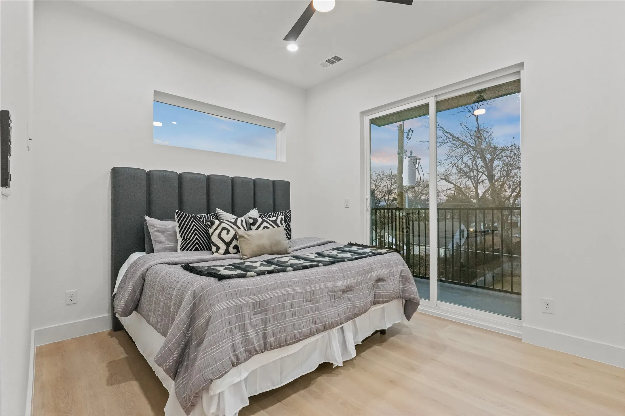 Bedroom featuring light wood finished floors, access to outside, and a ceiling fan