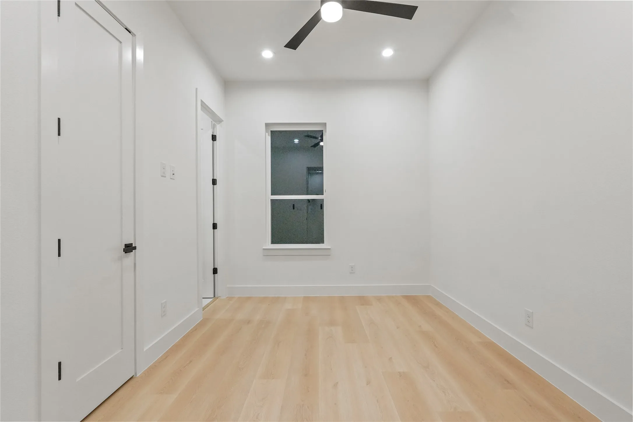 Unfurnished bedroom with light wood finished floors, a ceiling fan, and recessed lighting