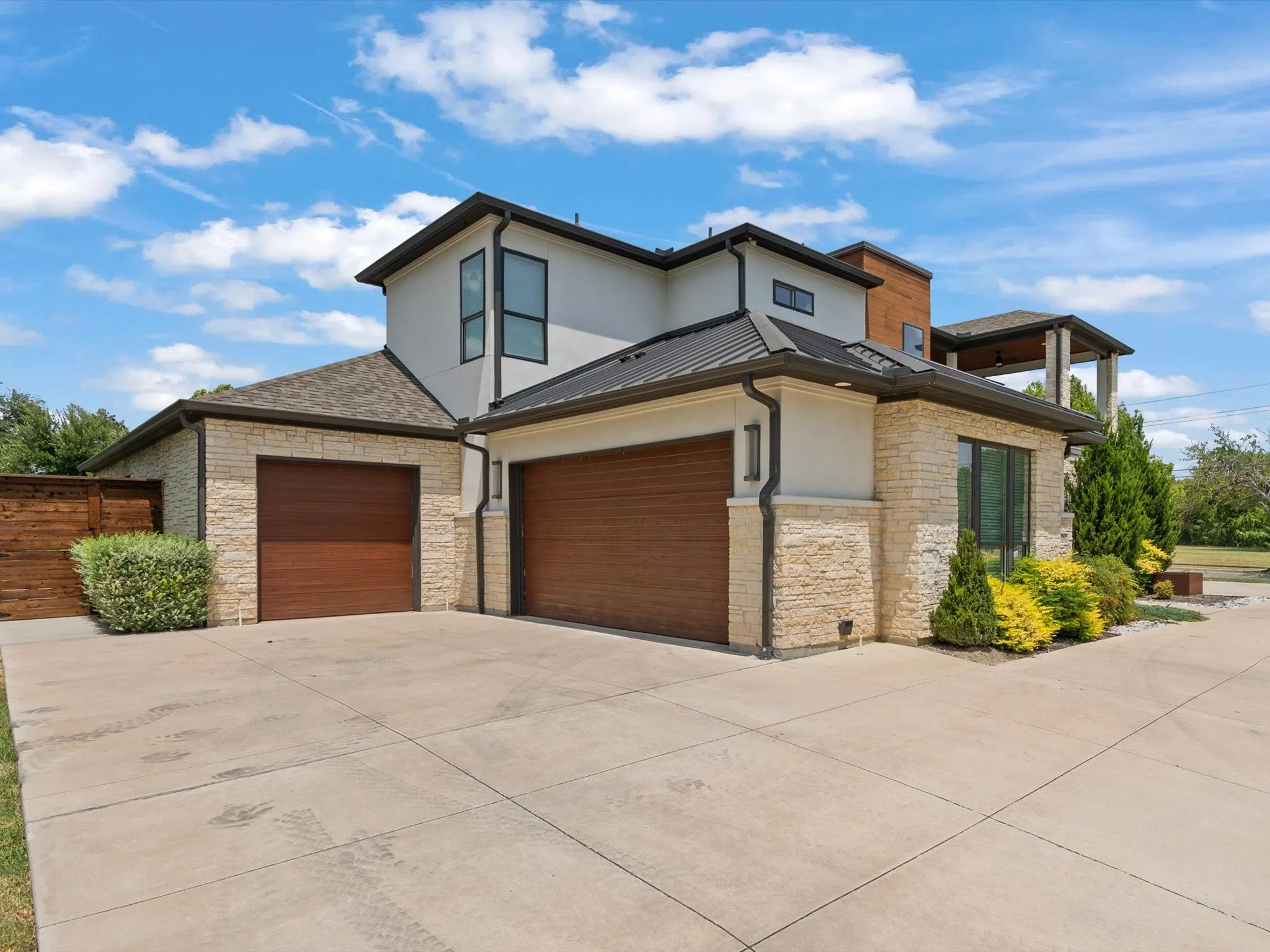Two-story exterior with light-colored stone and stucco finishes