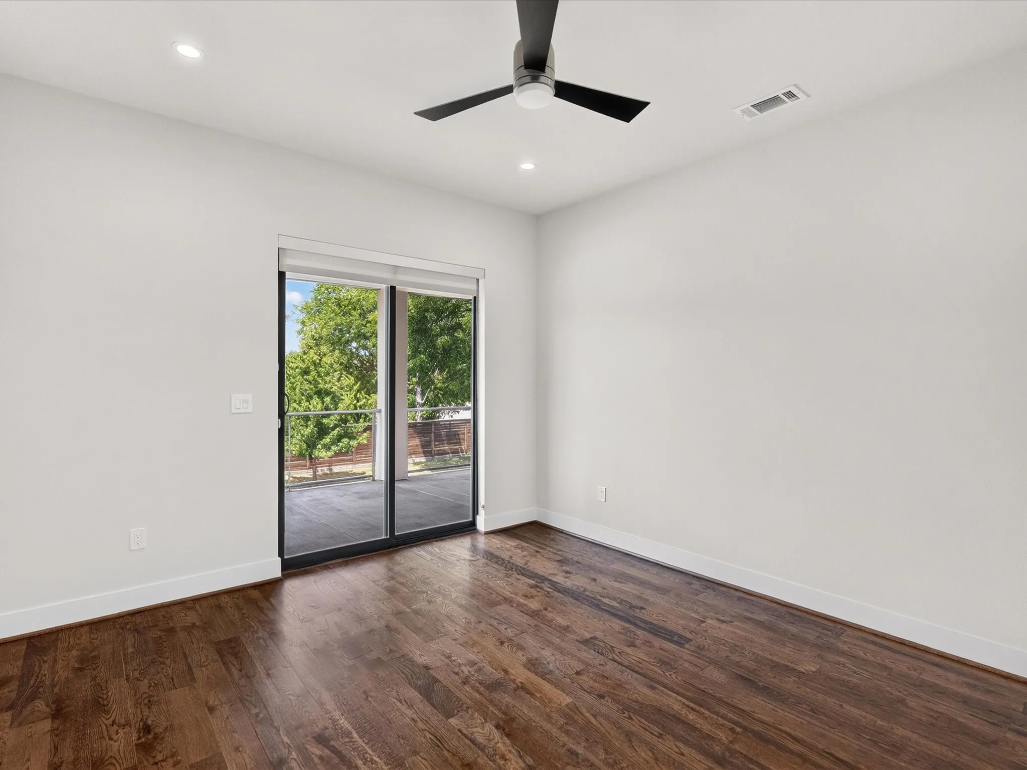 Dark wood-finish flooring, recessed lighting, and a ceiling fan
