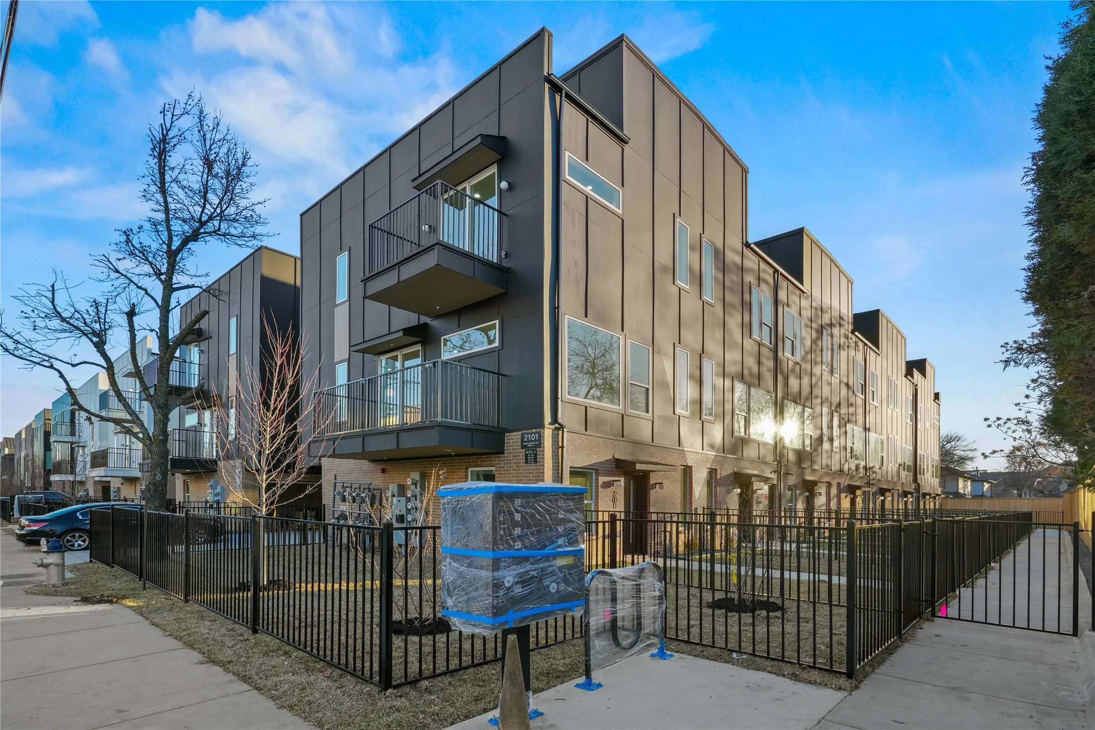 View of apartment building / complex with a fenced front yard
