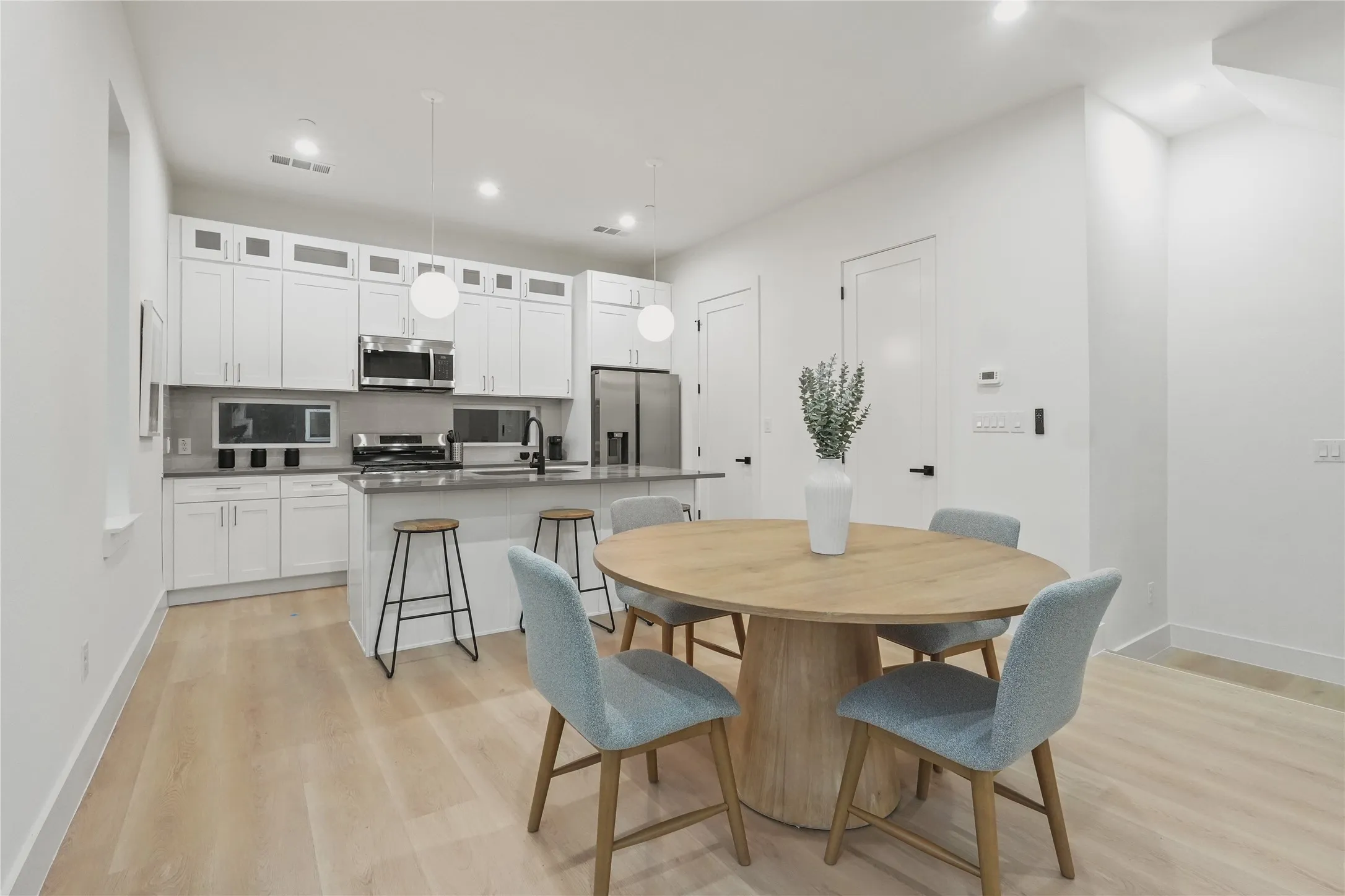Dining space with light wood-style flooring and recessed lighting