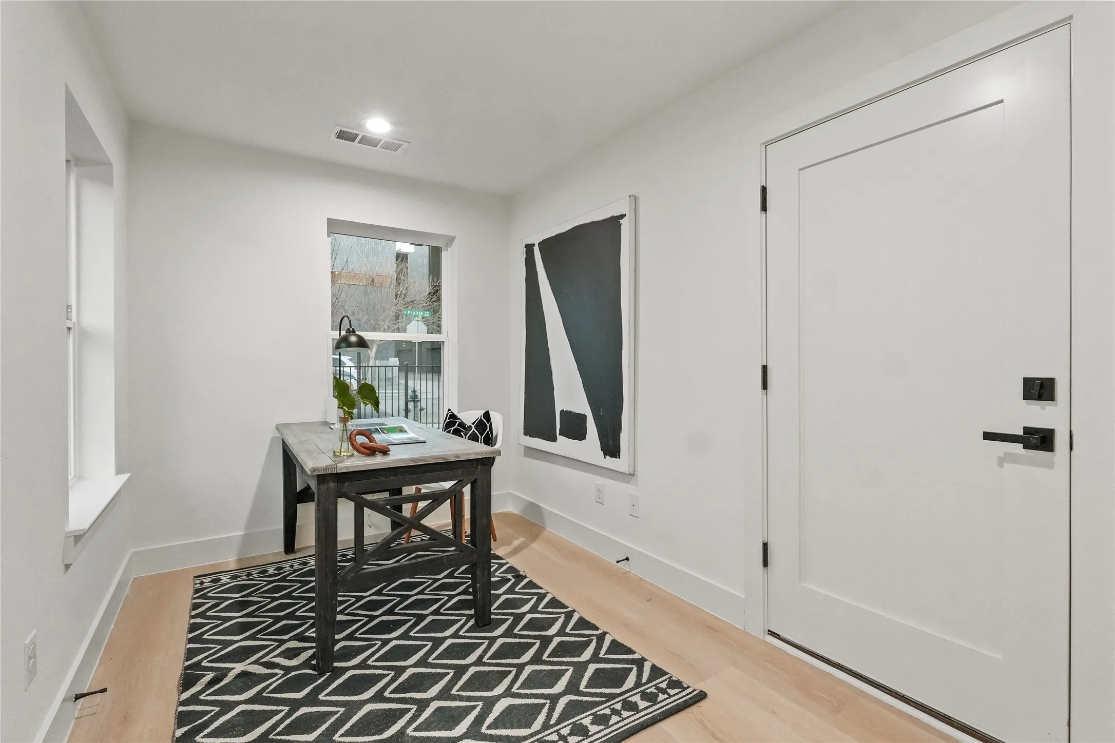 Office area featuring light wood-type flooring and baseboards