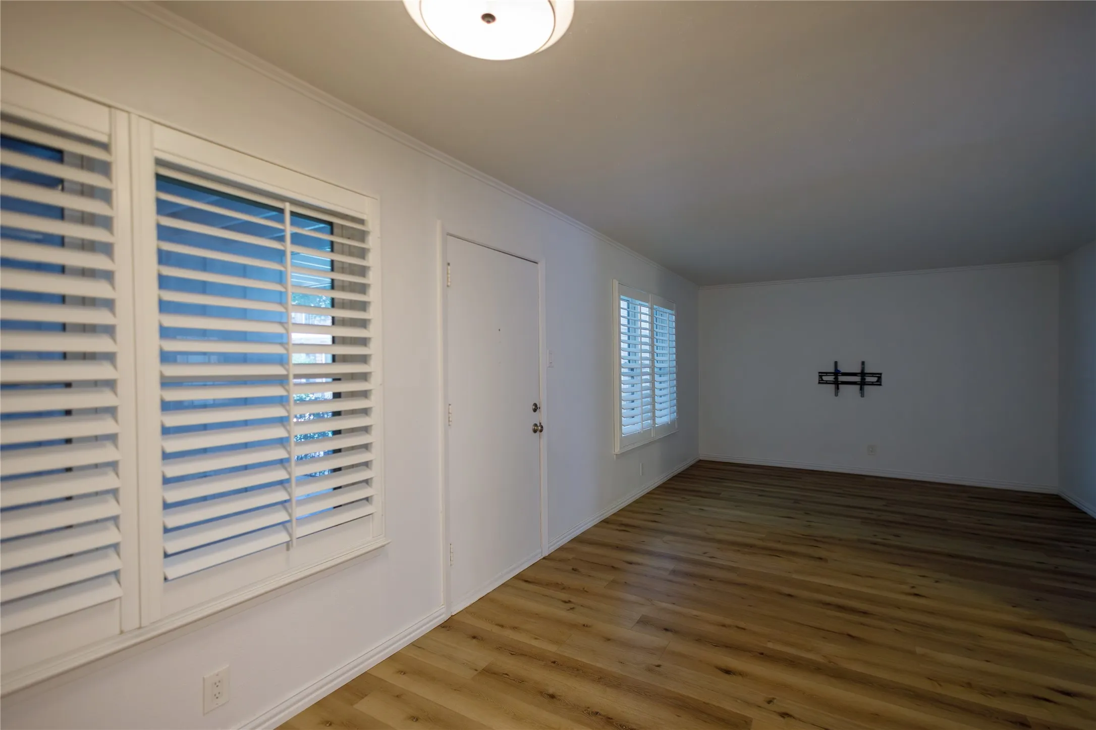 Living and dining room features plantation shutters