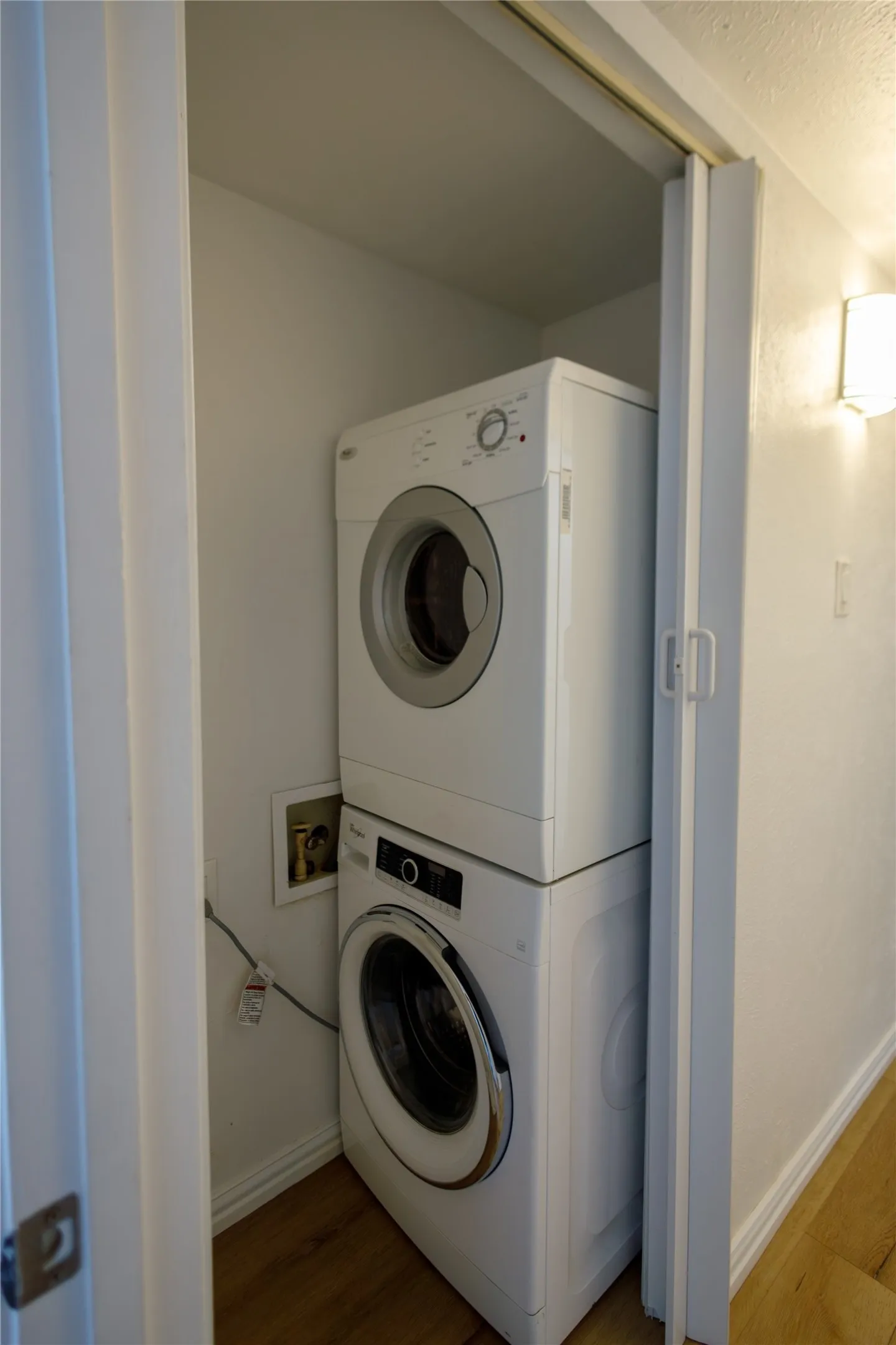 Stackable washer and dryer unit within a dedicated utility closet