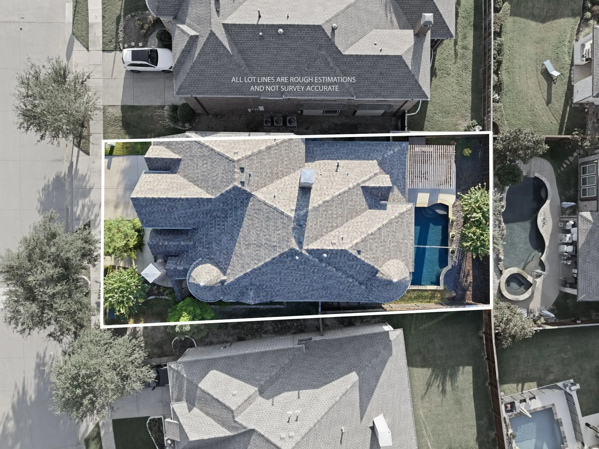 Property featuring a multi-gabled roofline, an attached garage, a private swimming pool, and established landscaping
