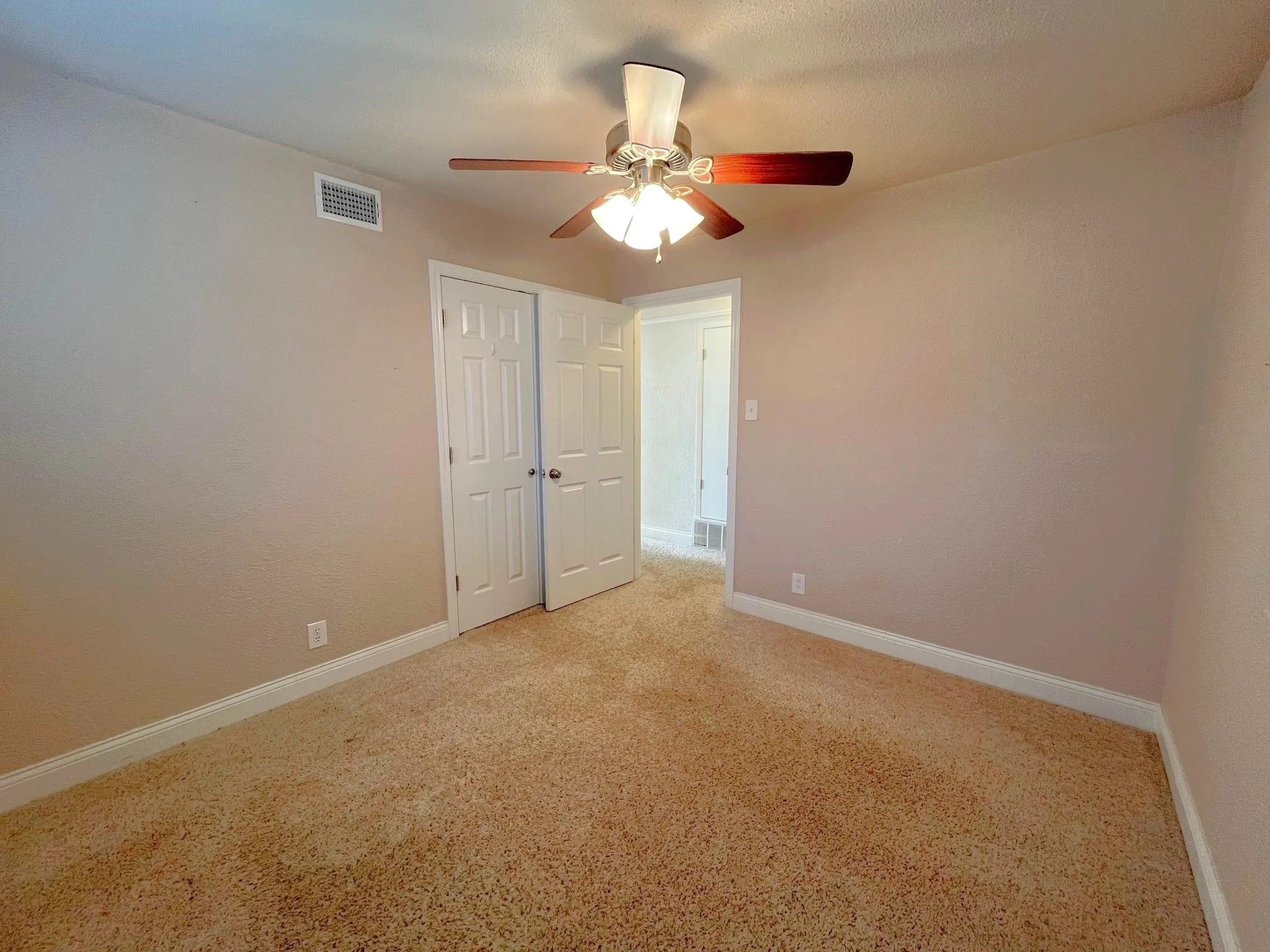Bedroom 1 Neutral tone wall finishes, carpeting, fan, and a window with blinds