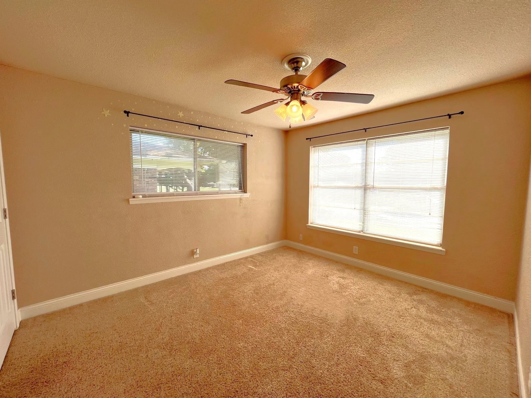 Bedroom 2 Neutral tone wall finishes, carpeting, fan, and a window with blinds