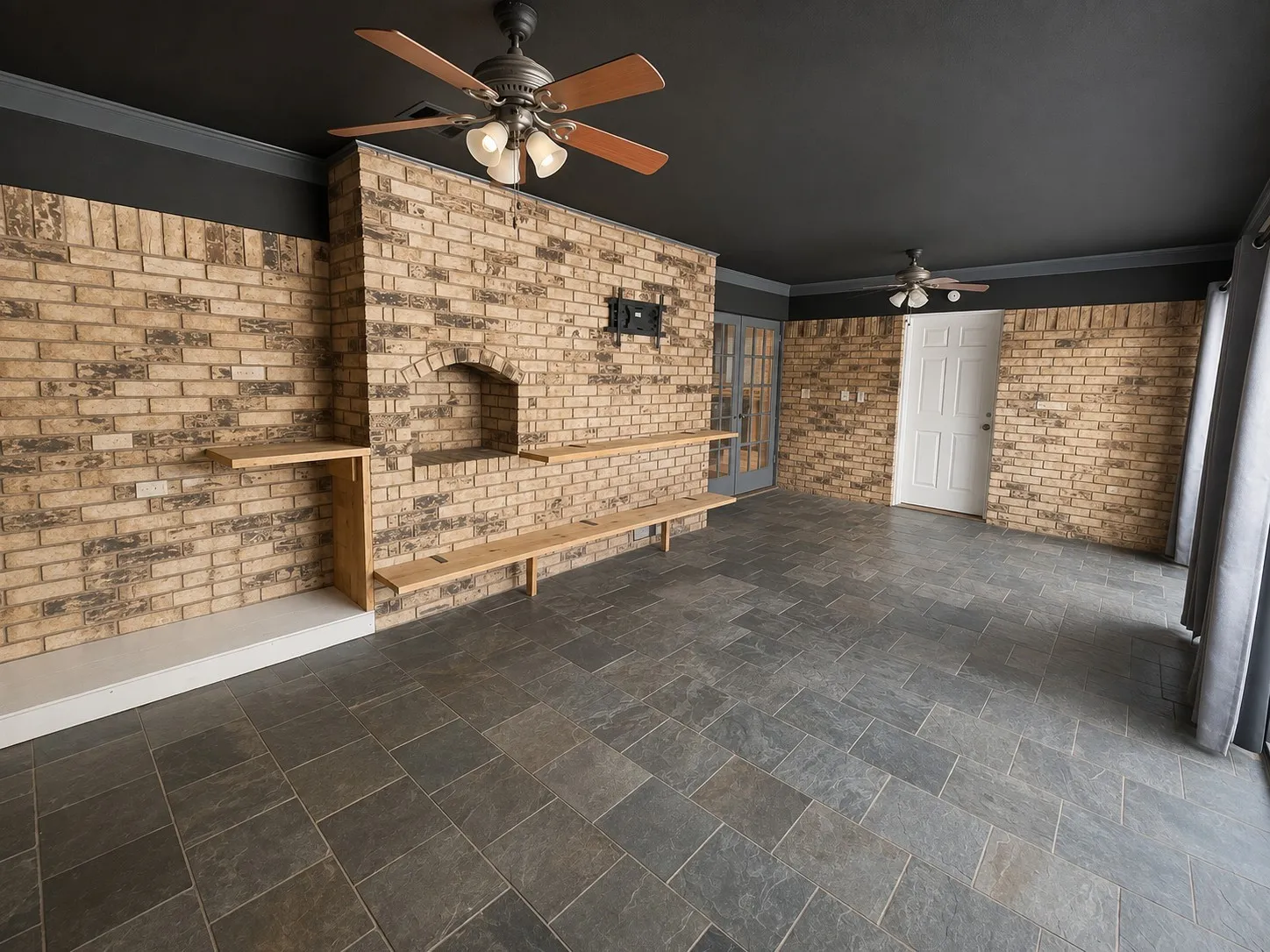 Sunroom with dark ceiling - 2 fans - beautiful brick work
