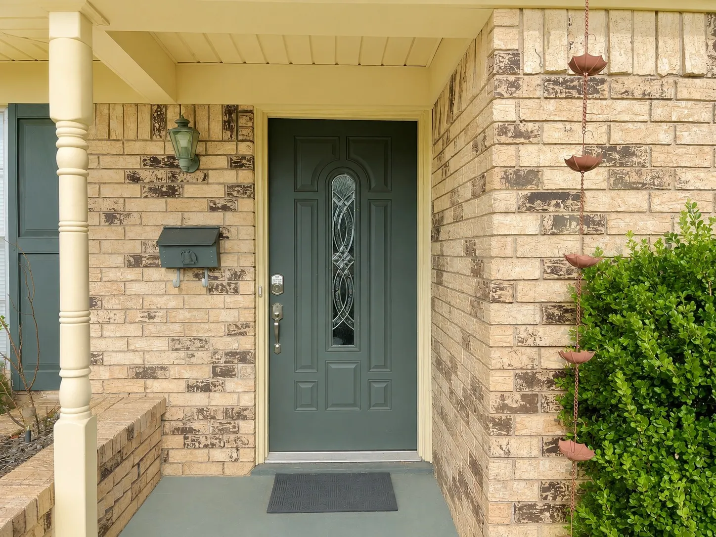Brick exterior including a beautiful door with decorative glass