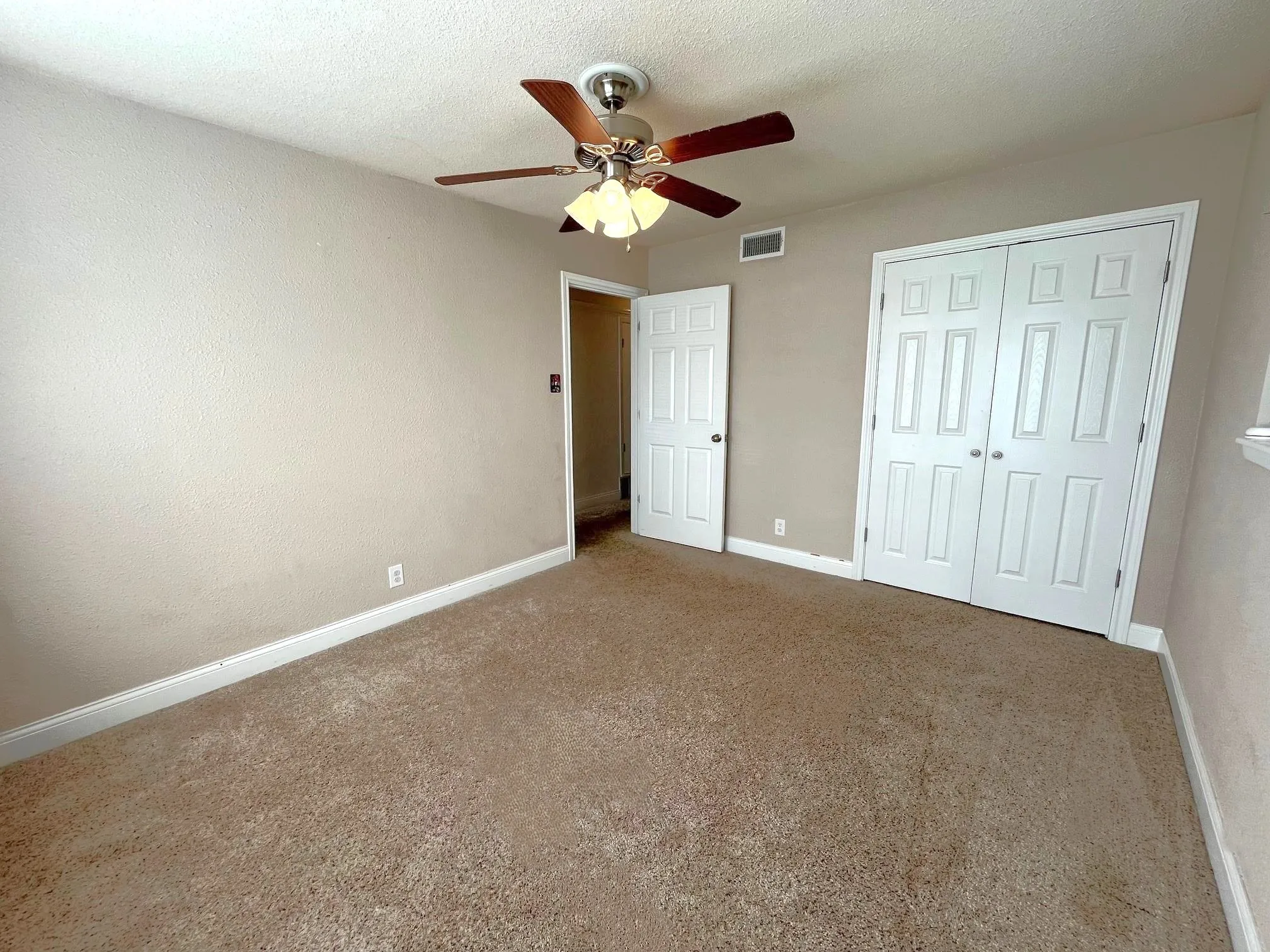 Bedroom 2 Neutral tone wall finishes, carpeting, fan, and a window with blinds