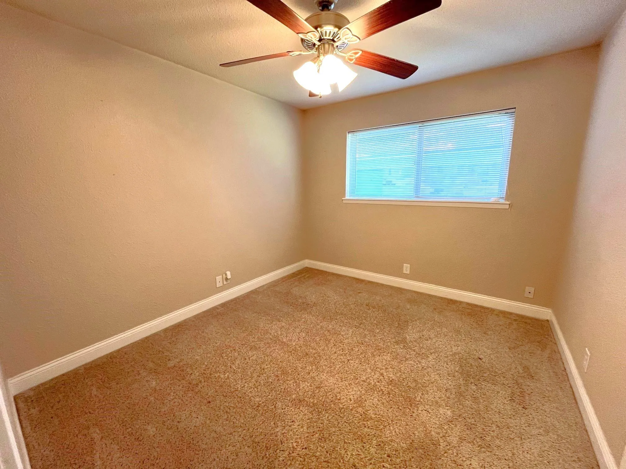 Bedroom 1 Neutral tone wall finishes, carpeting, fan, and a window with blinds