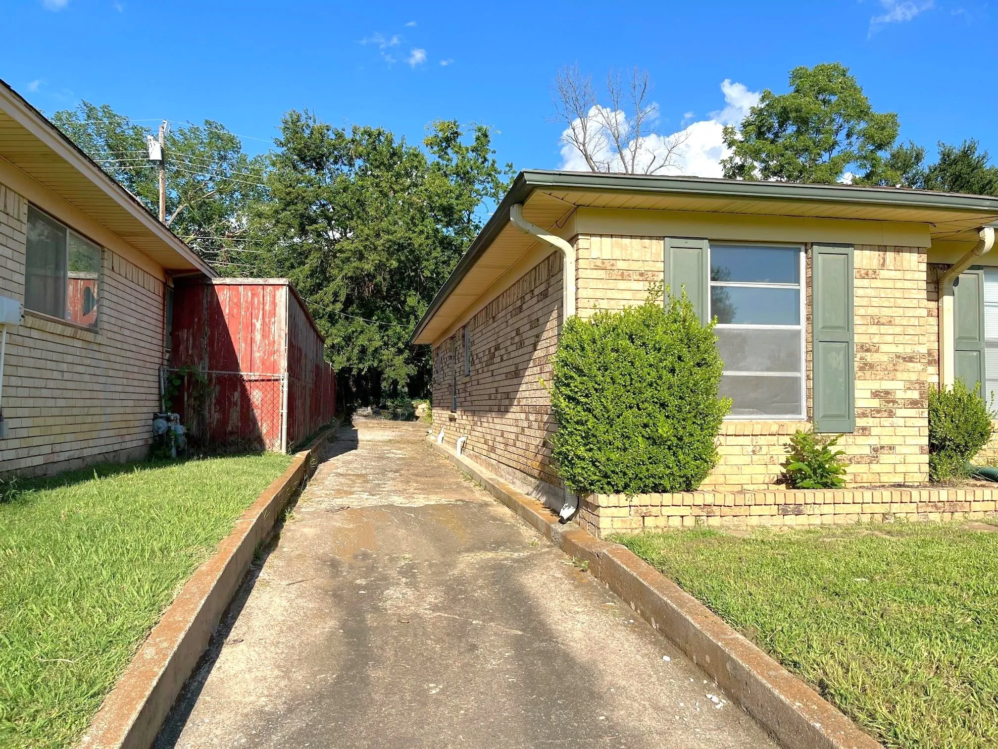 Brick exterior with window shutters and established landscaping