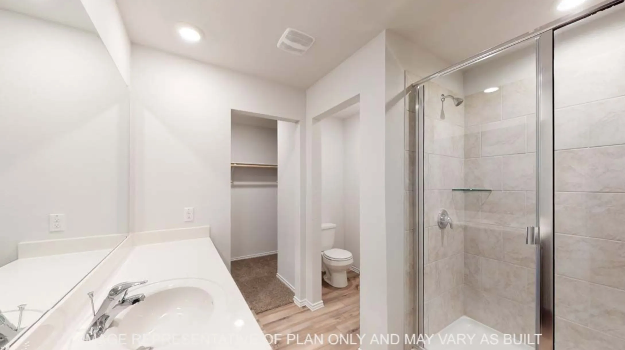 White vanity with integrated sink, chrome faucet, and expansive wall mirror