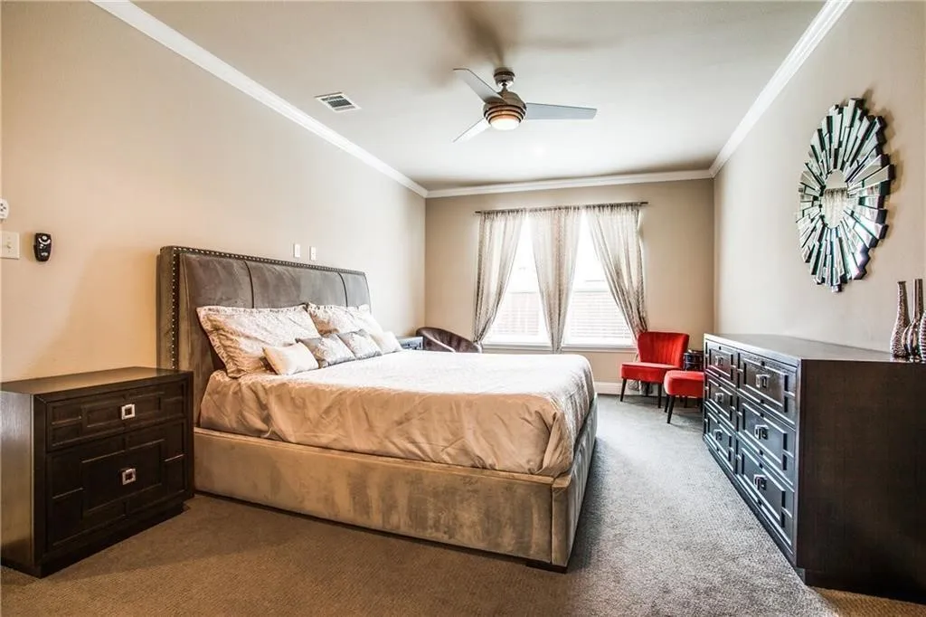Recessed lighting, crown molding, and a ceiling fan with integrated lighting