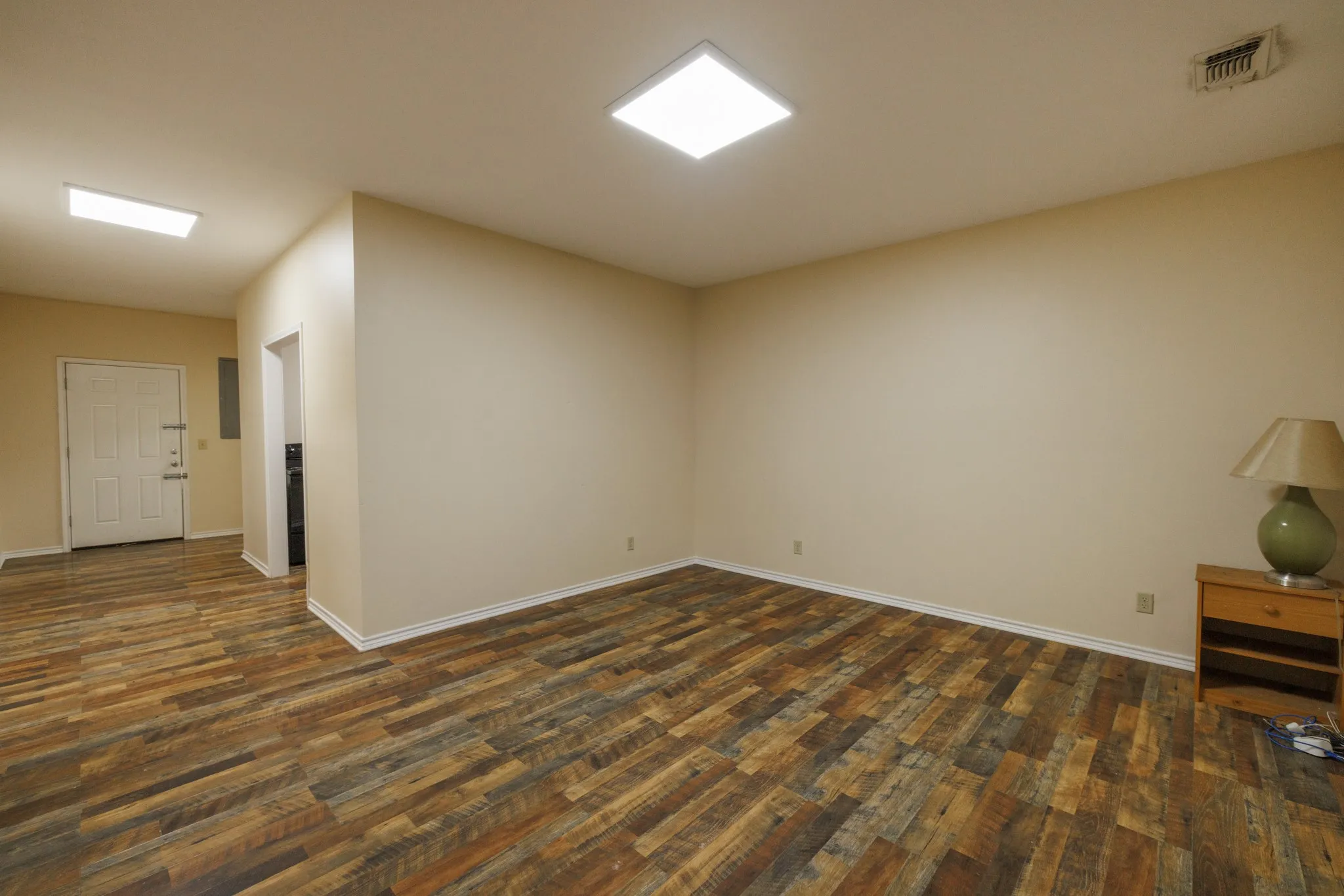 Wood-finish flooring throughout, neutral wall tones, and recessed ceiling lighting