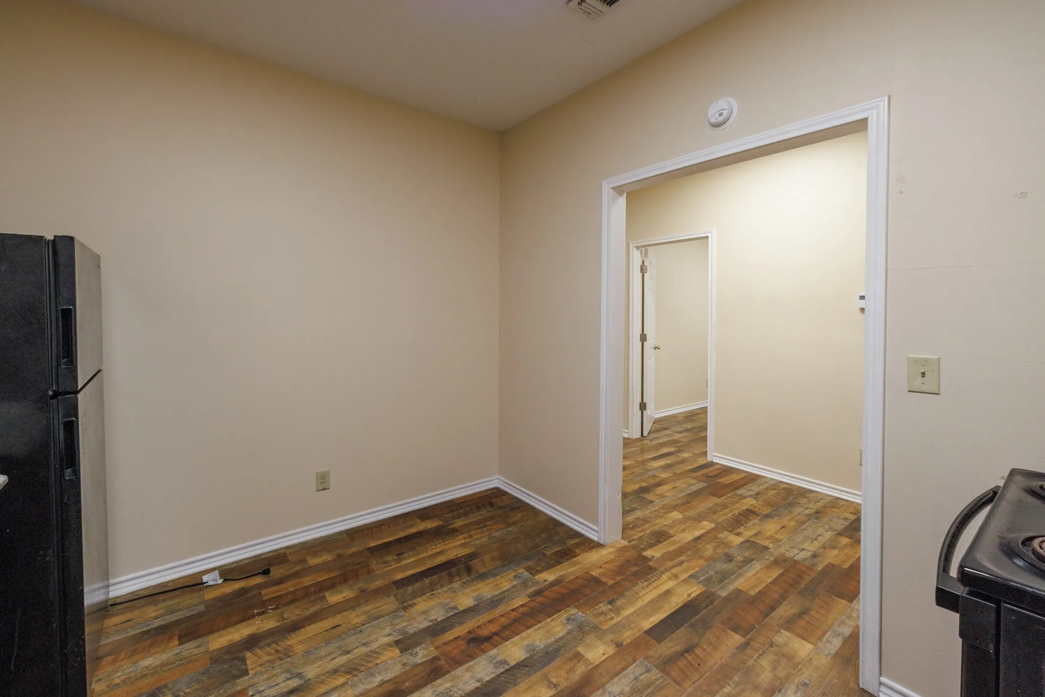 Wood-finish flooring throughout, complemented by light-colored walls and white trim