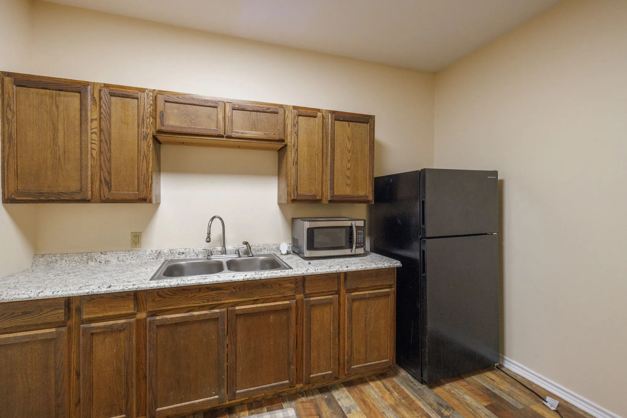 Wood-finish cabinetry paired with light-toned countertops