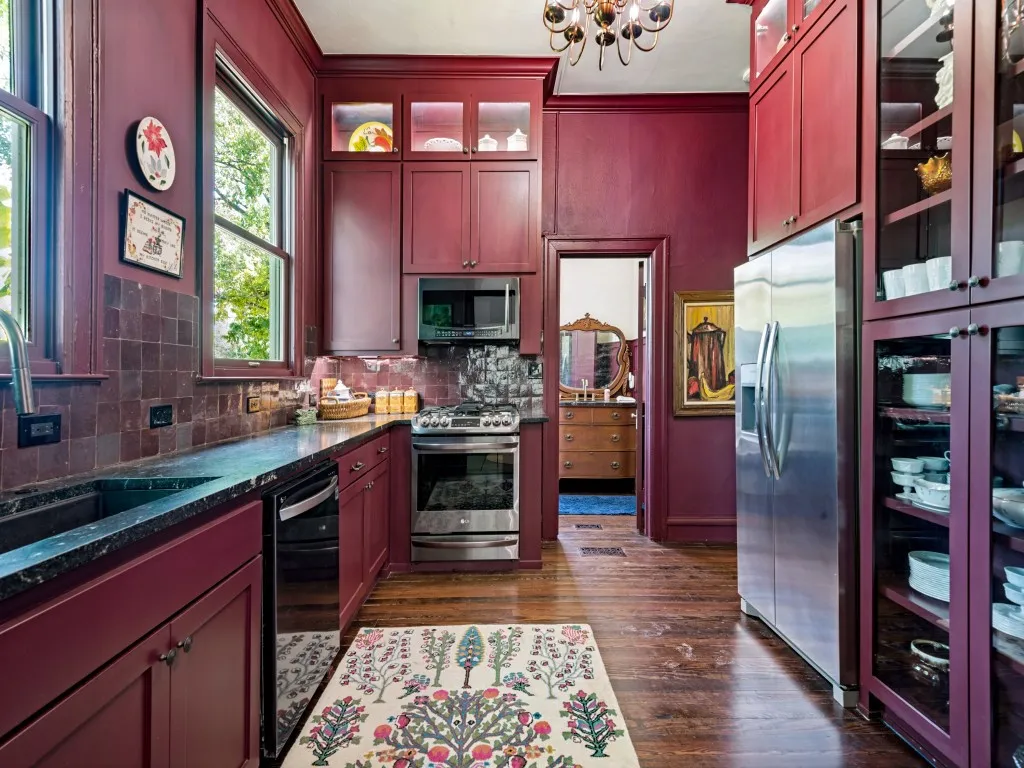 Kitchen featuring floor to ceiling cabinets and original pine flooring