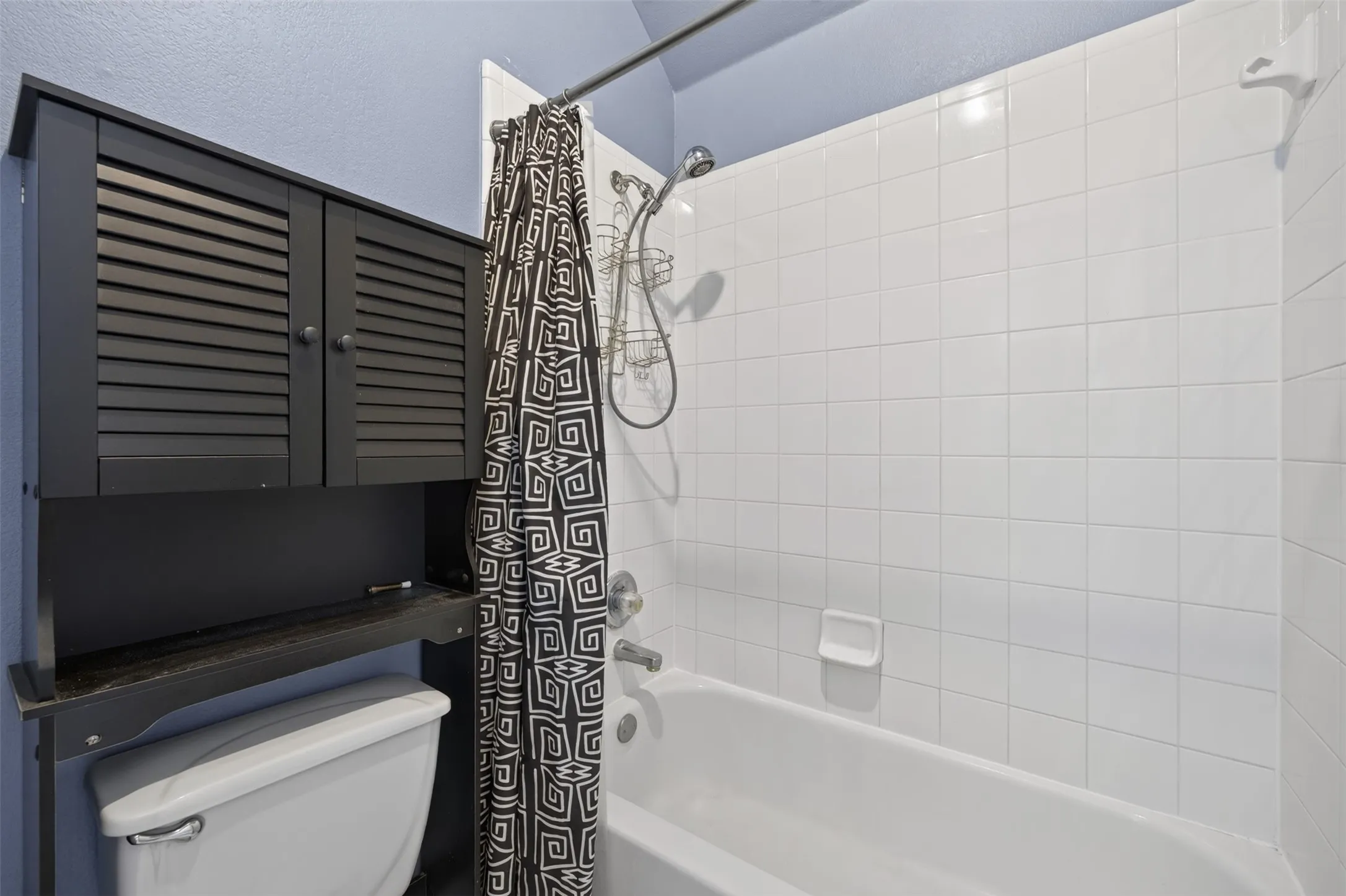 White tile shower surround with integrated soap dish