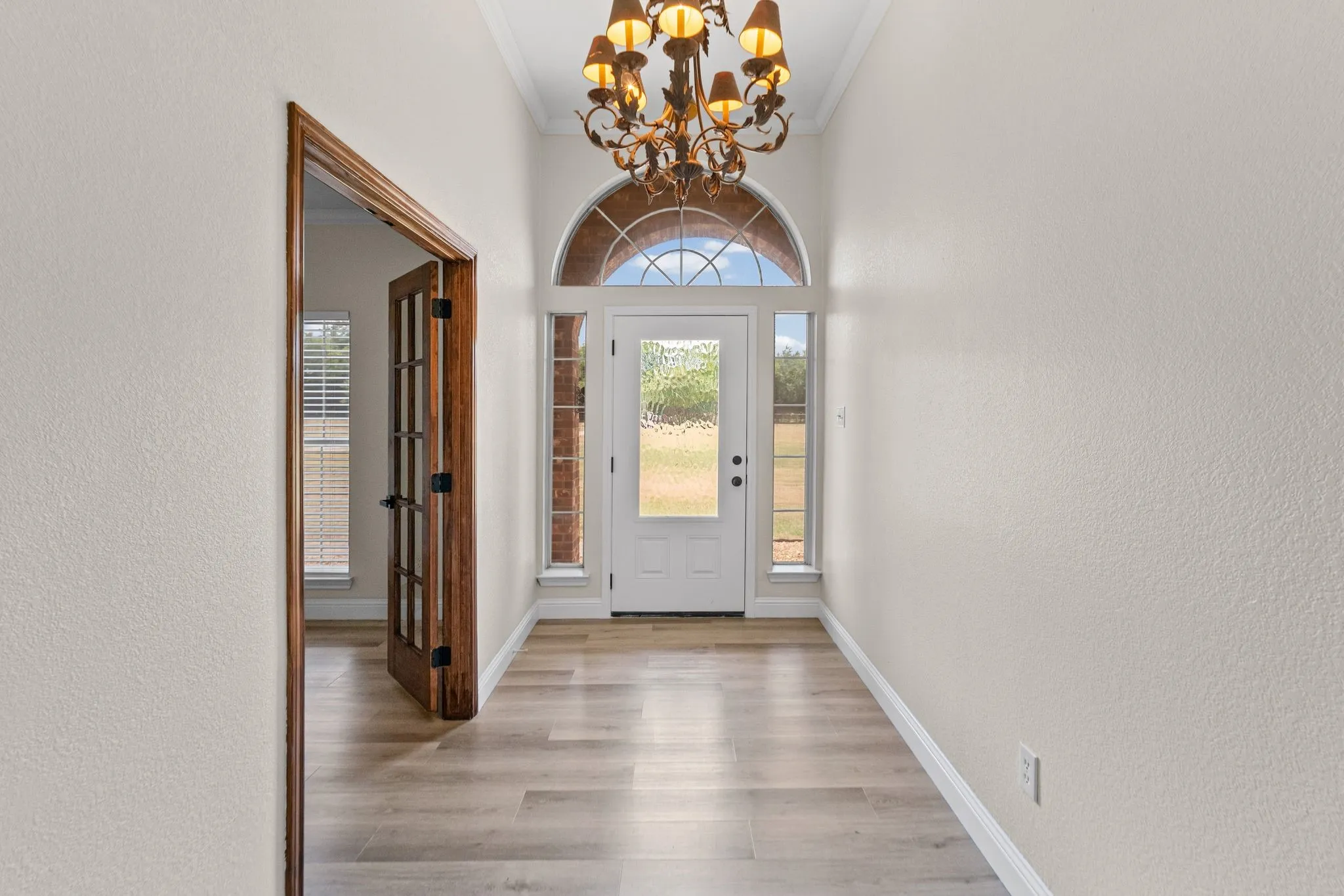 Entryway featuring is bright with multi-purpose room on left.