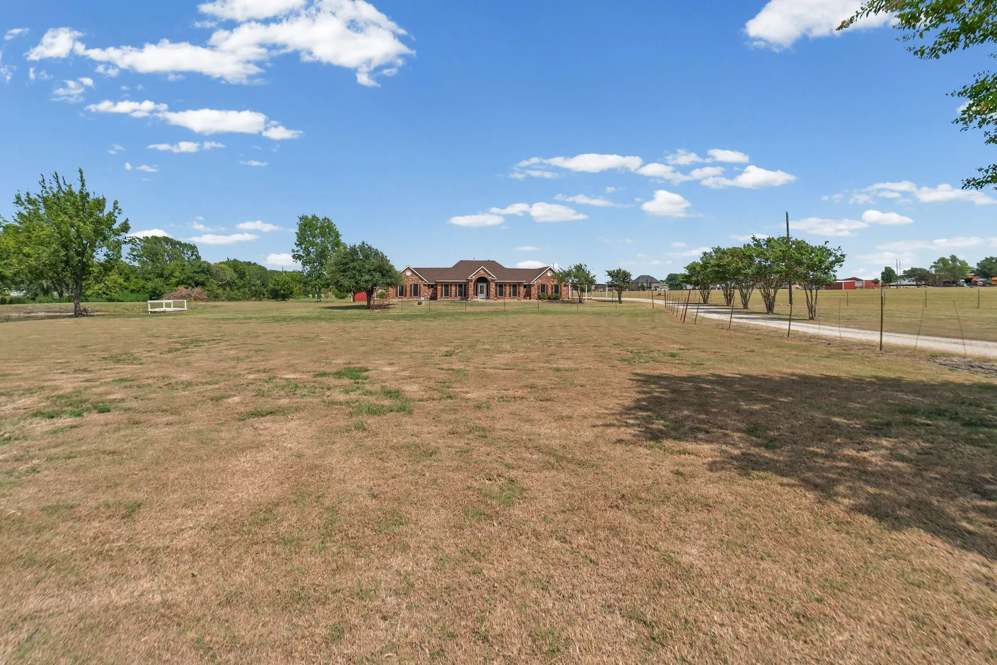 Front view of home with pond and pier on left.