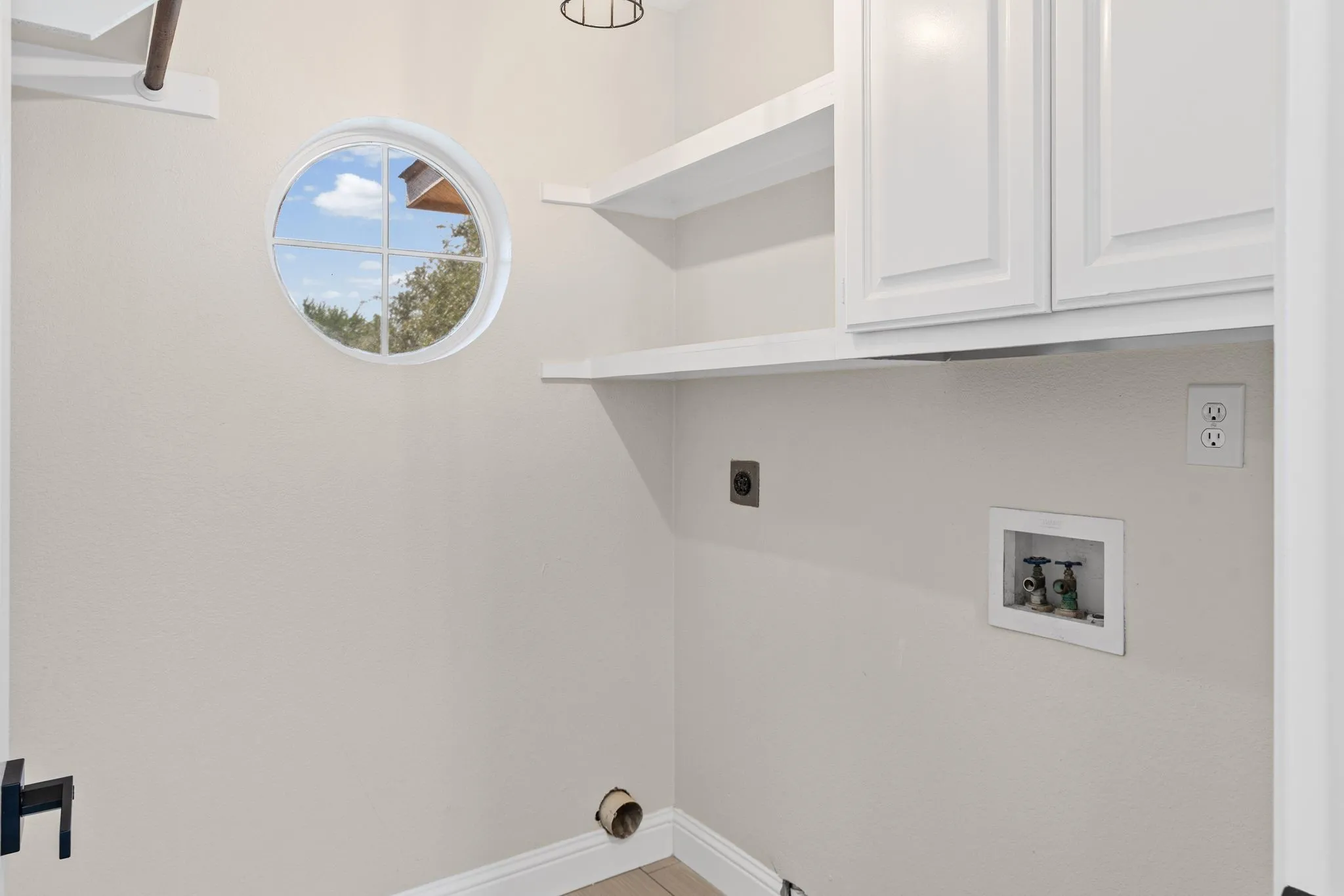 Utility room has space for full size washer and dryer, cabinet space for supplies and a linen closet.