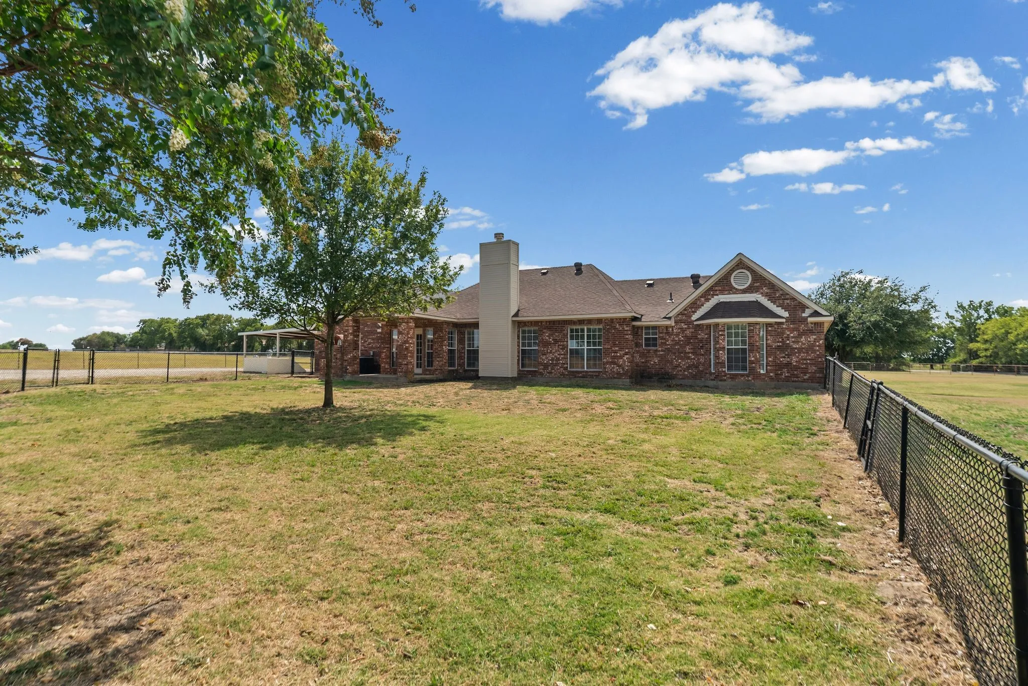 Brick exterior with gabled roofline and chimney