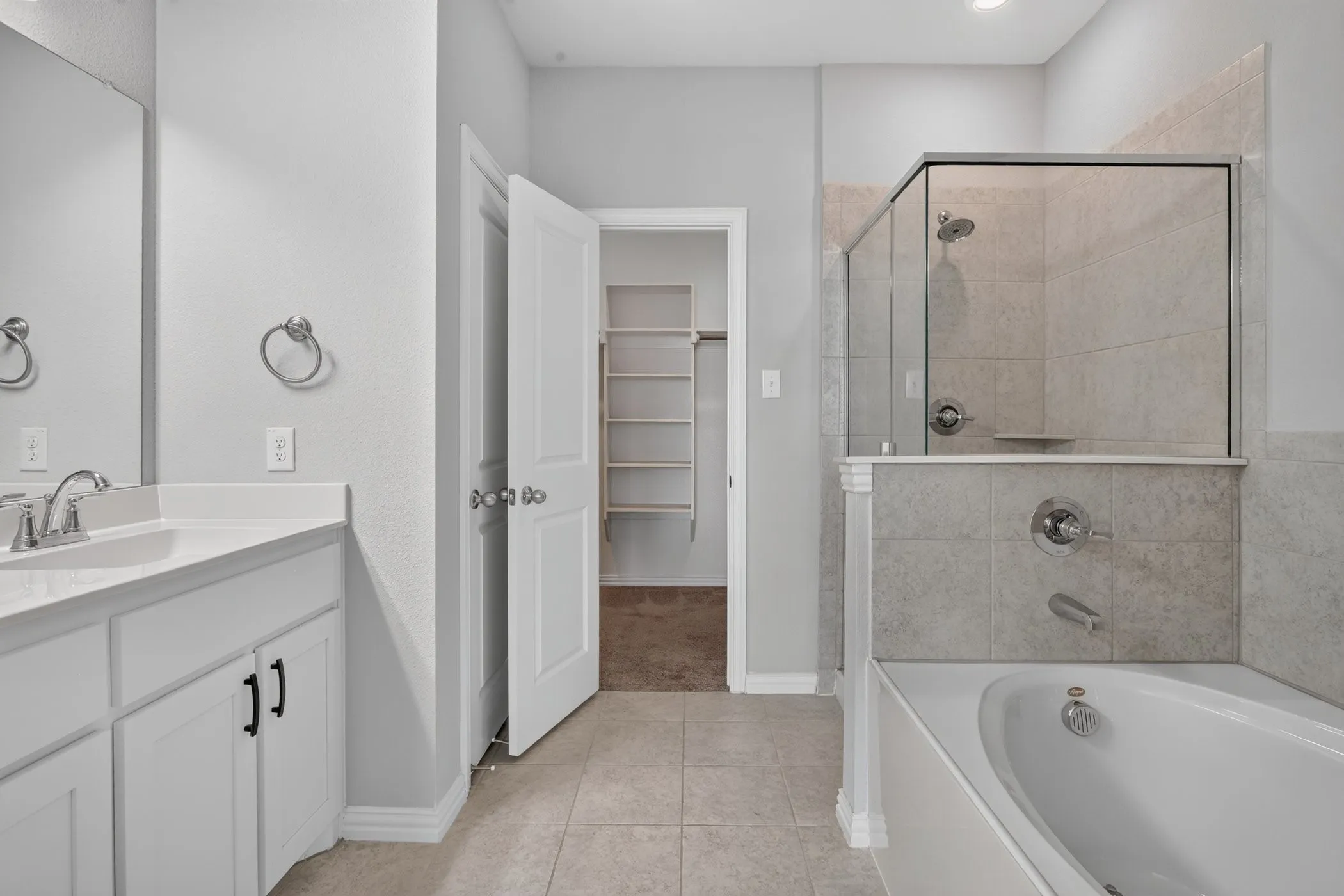 White vanity with a single basin sink and chrome faucet