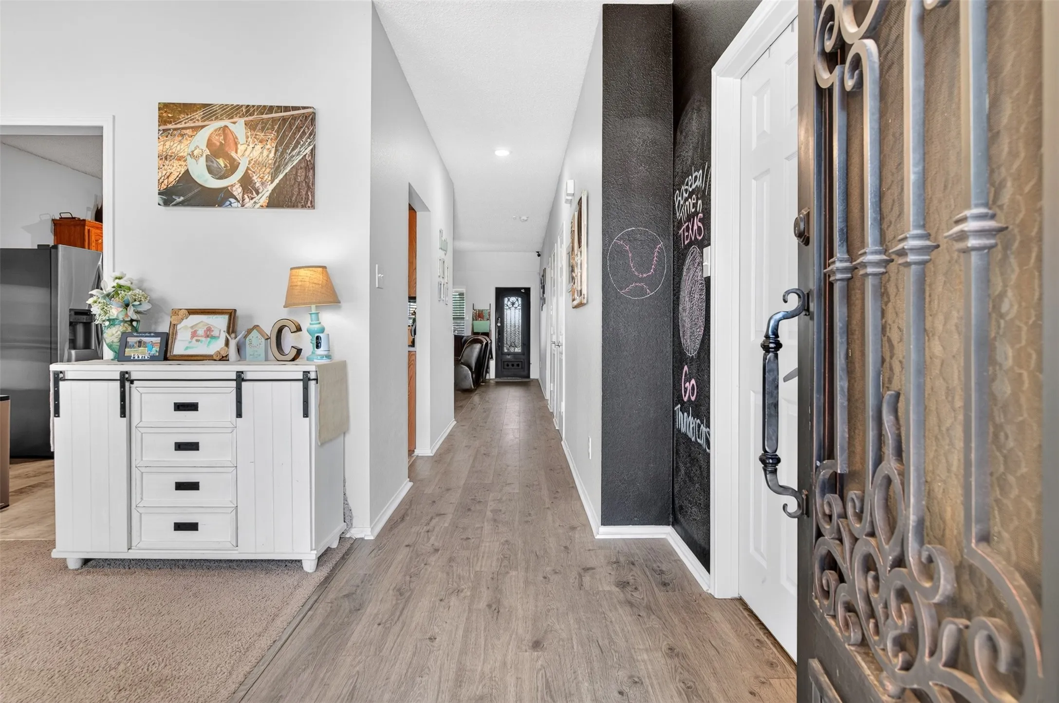 Entry front door on the right  view to the back door also Love That Door dining to the left and office to the right