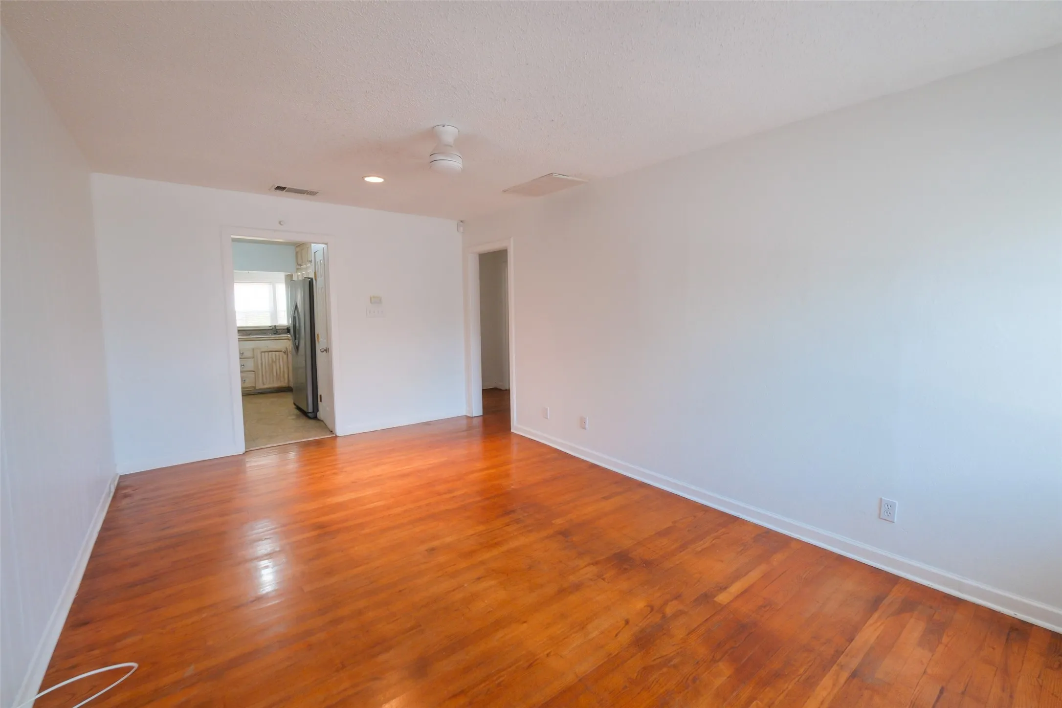 Wood-finish flooring, recessed lighting, and a ceiling fan