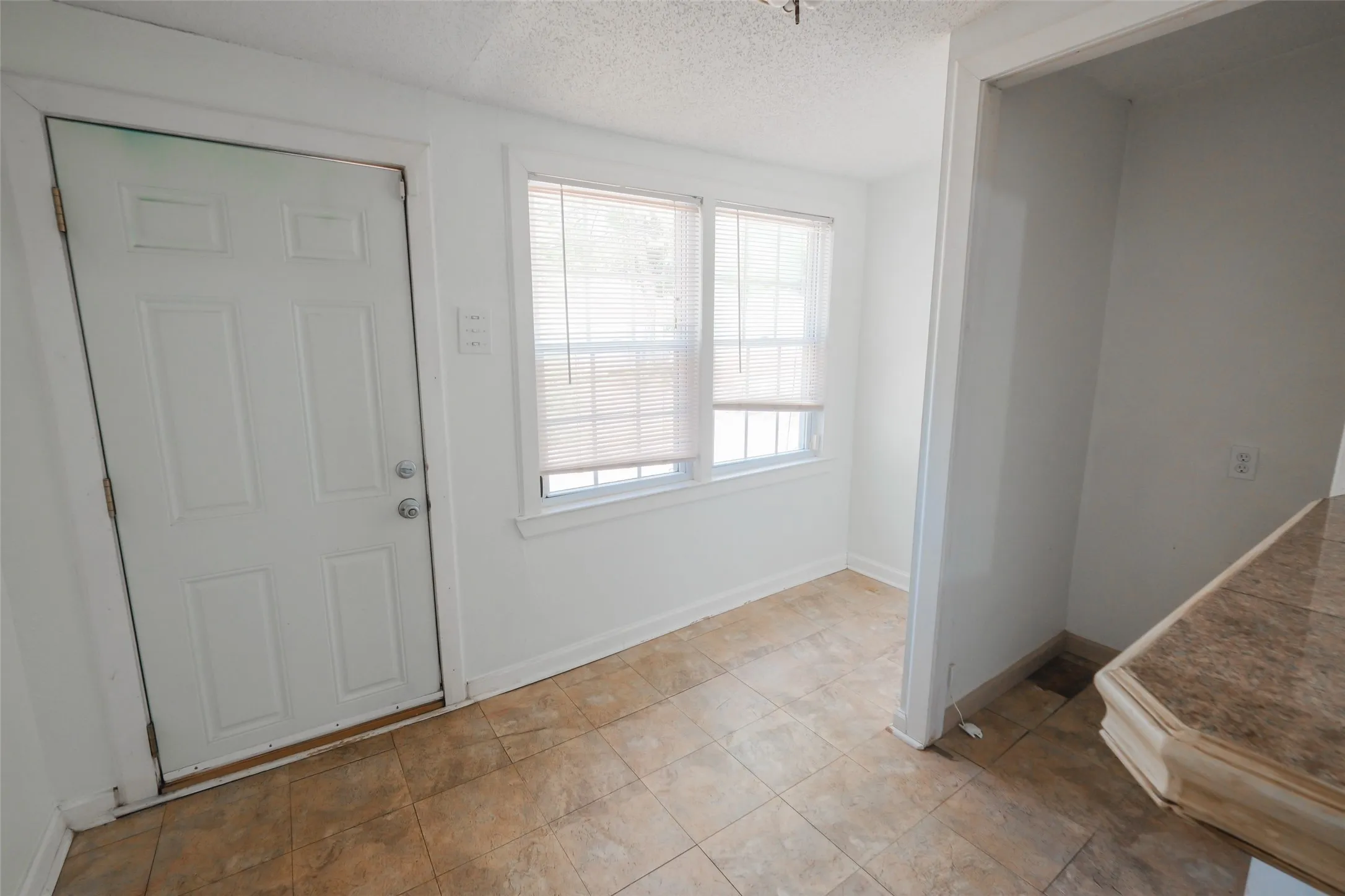 Tiled flooring and white paneled door
