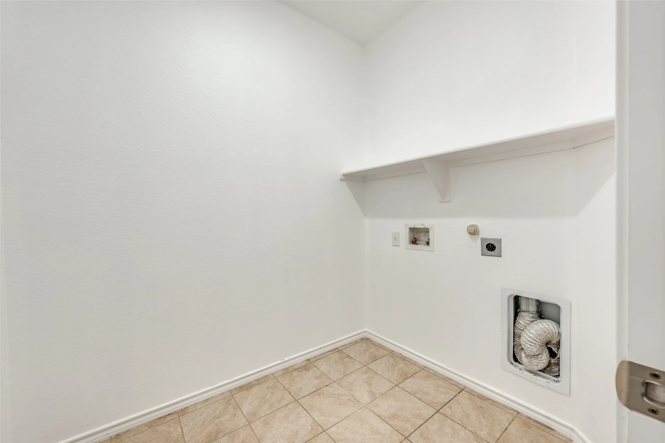 Separate room for the washer dryer, you don't have to go through the garage to get to it!
