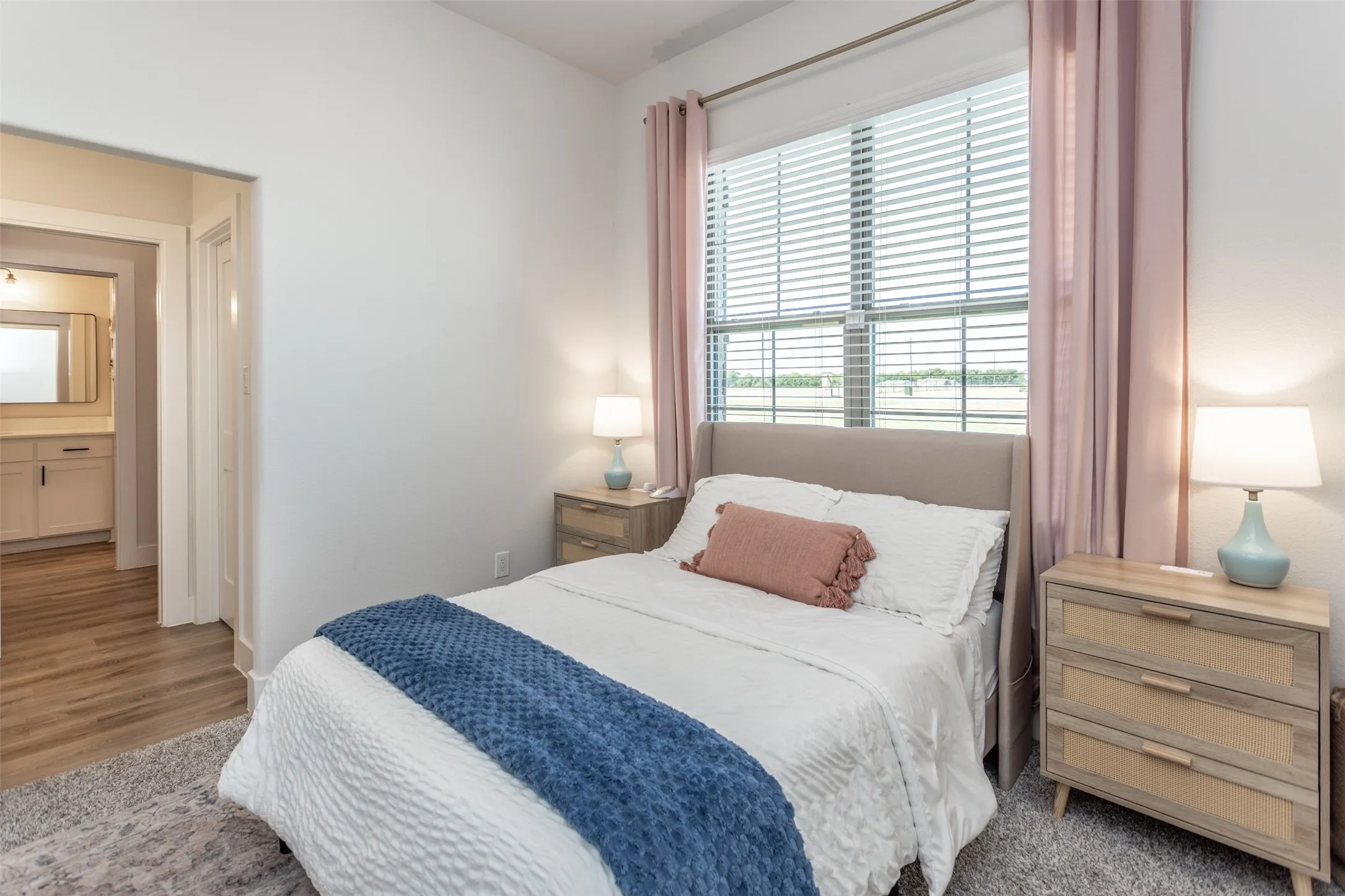 Window with horizontal blinds and drapery rods