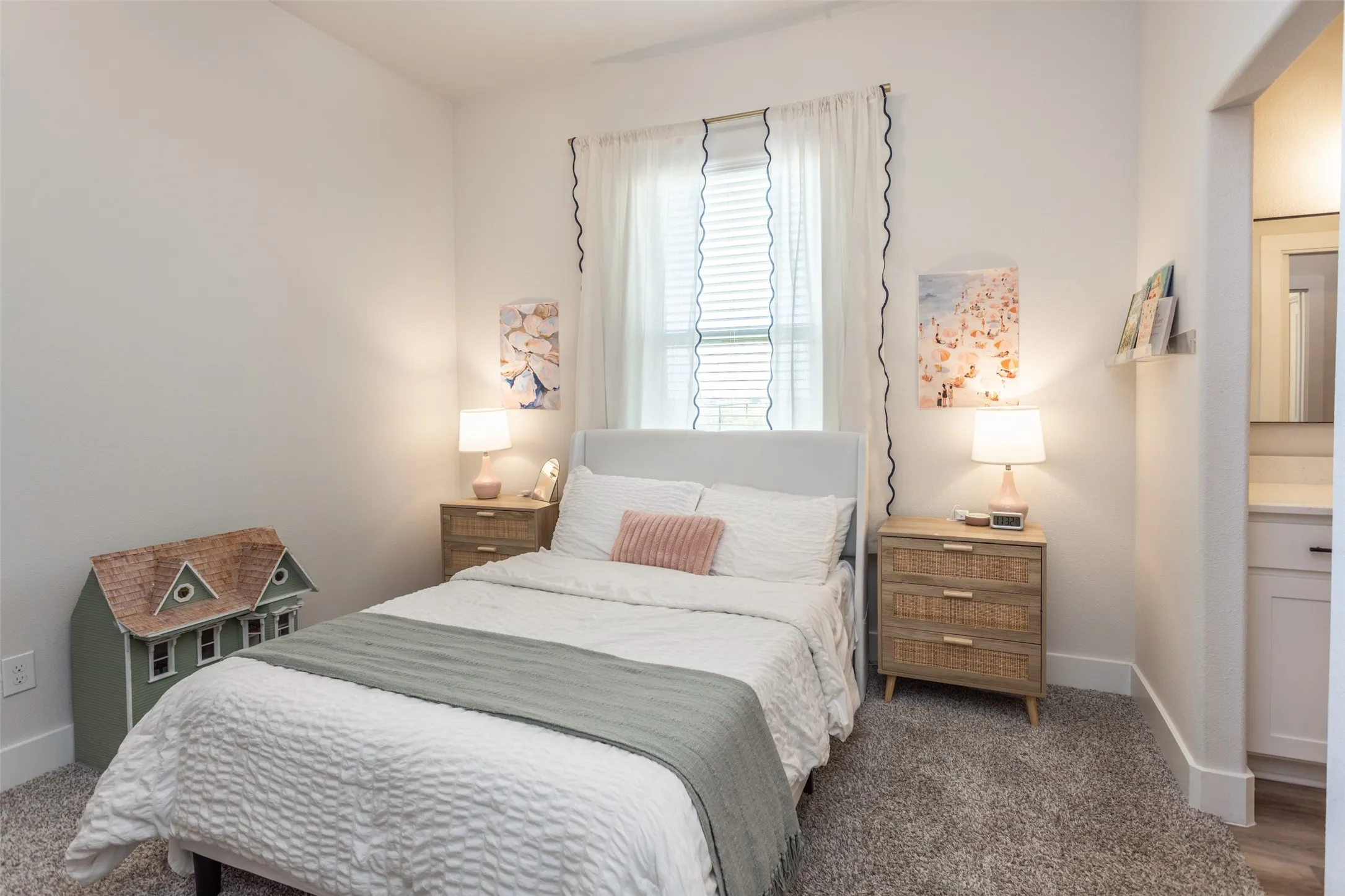 Carpeted room with white walls, window with blinds, and white trim