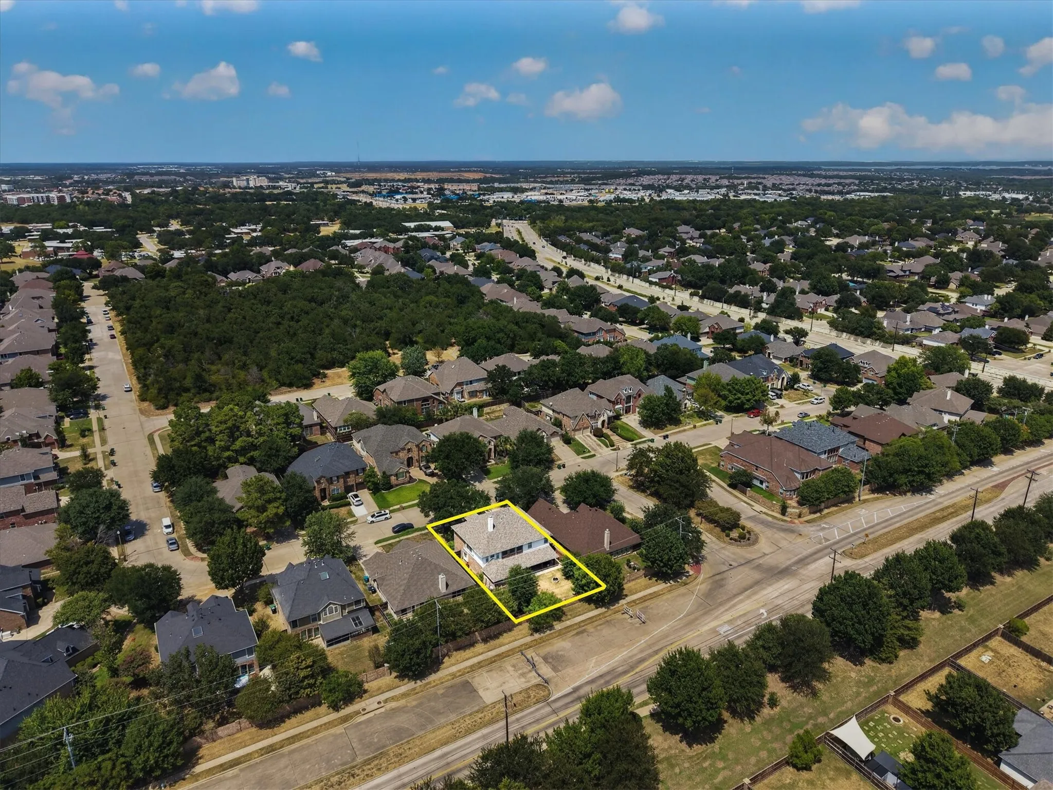 Aerial perspective showcasing a residential property within a developed neighborhood
