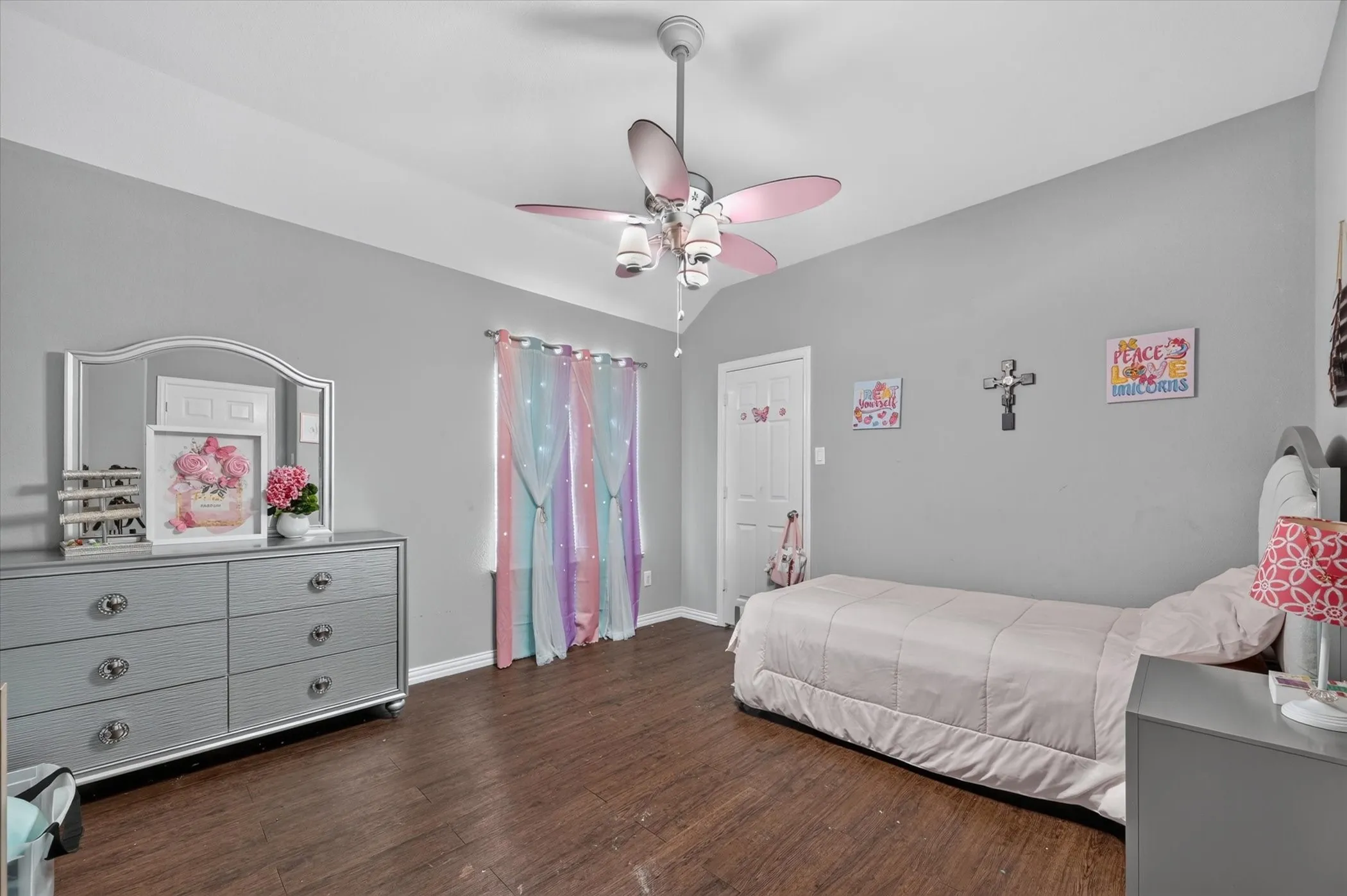 Wood-finish flooring with a ceiling fan and overhead lighting