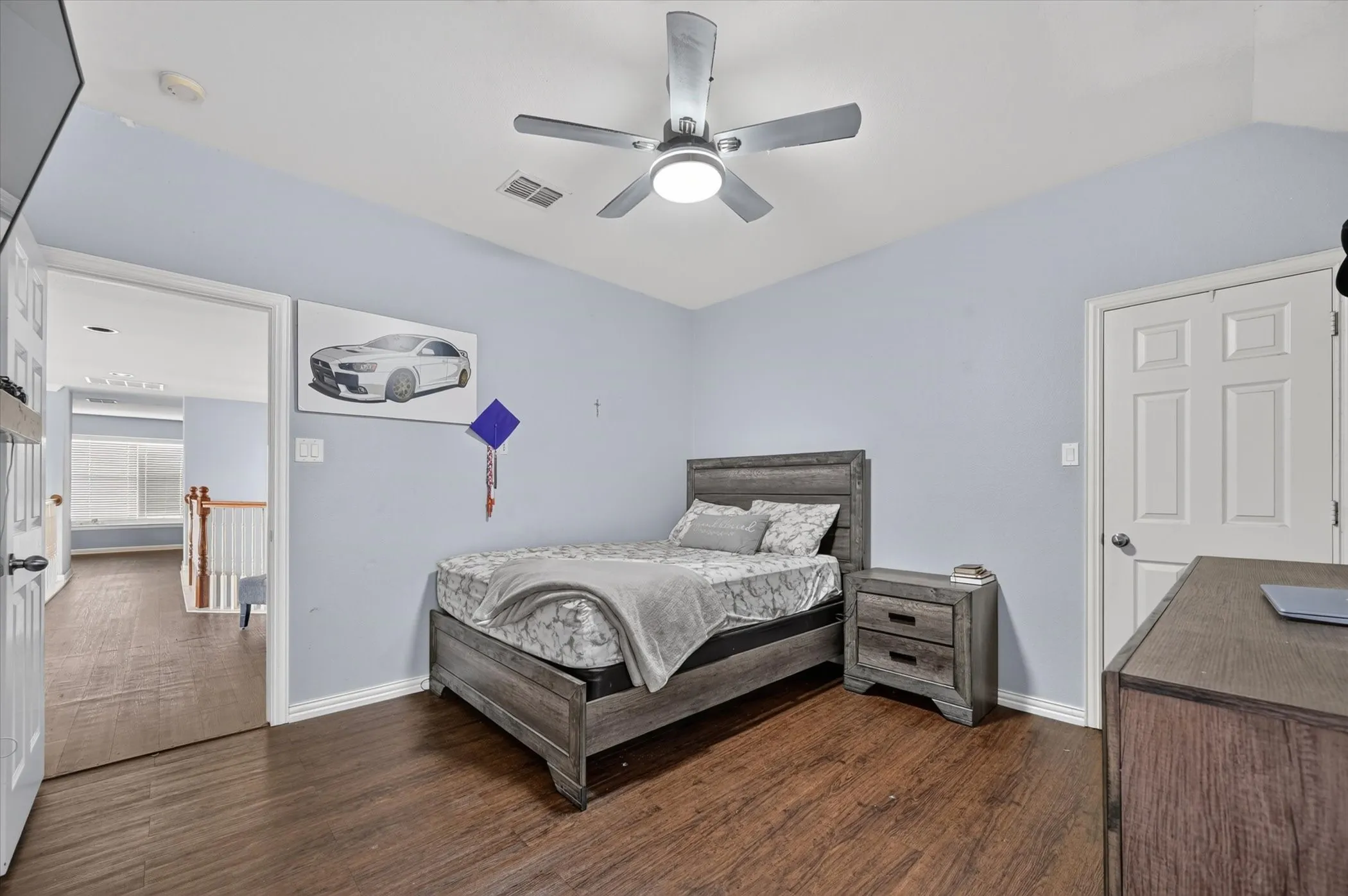 Wood-finish flooring with a ceiling fan light fixture