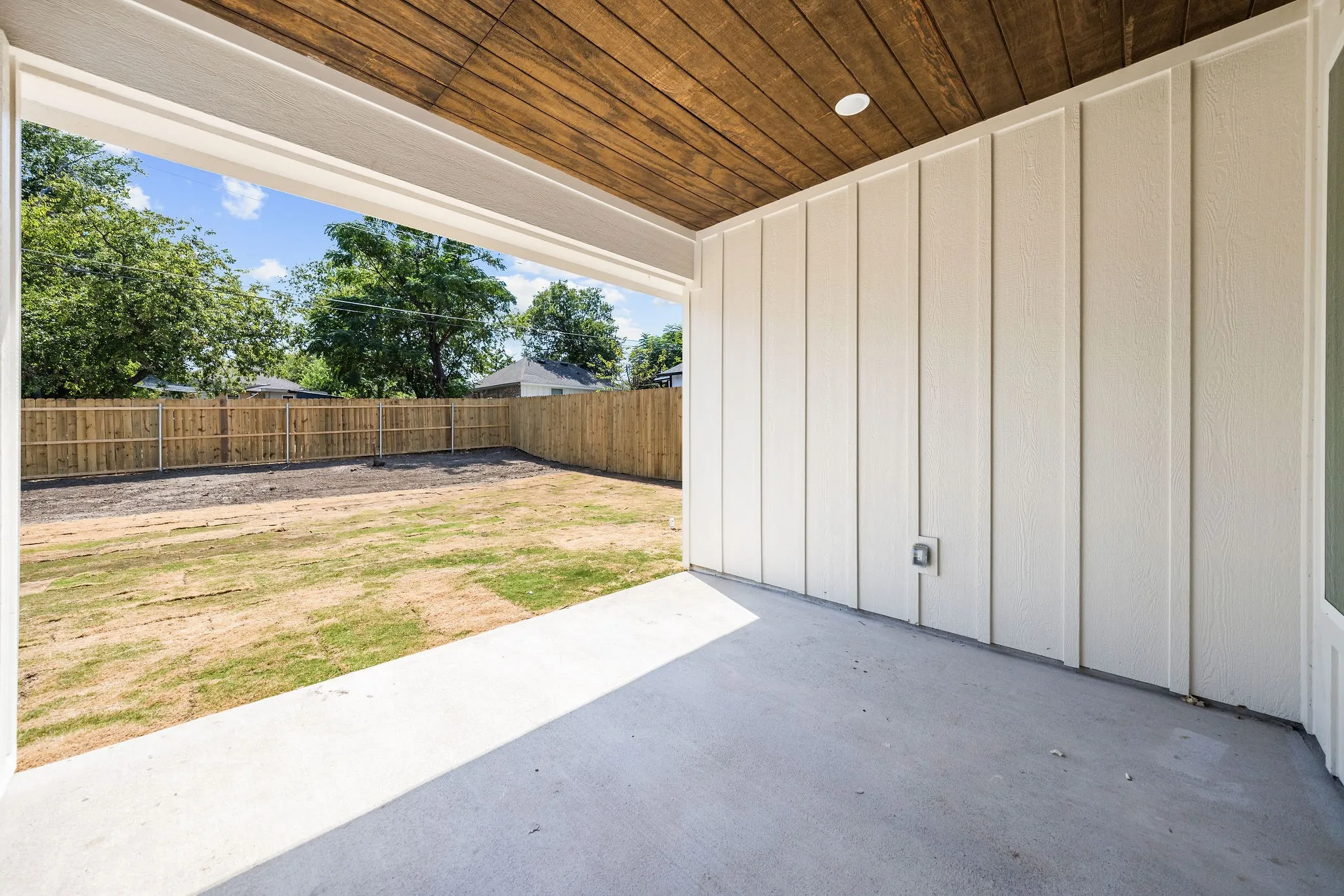 Covered patio featuring a wood-finish ceiling, recessed lighting, concrete flooring, and board and batten siding