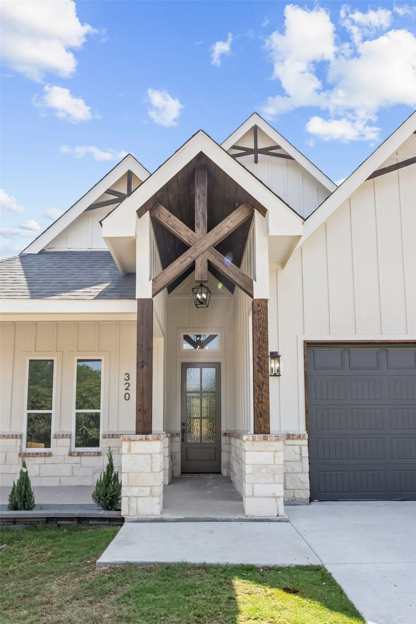 White board-and-batten exterior with stone accents