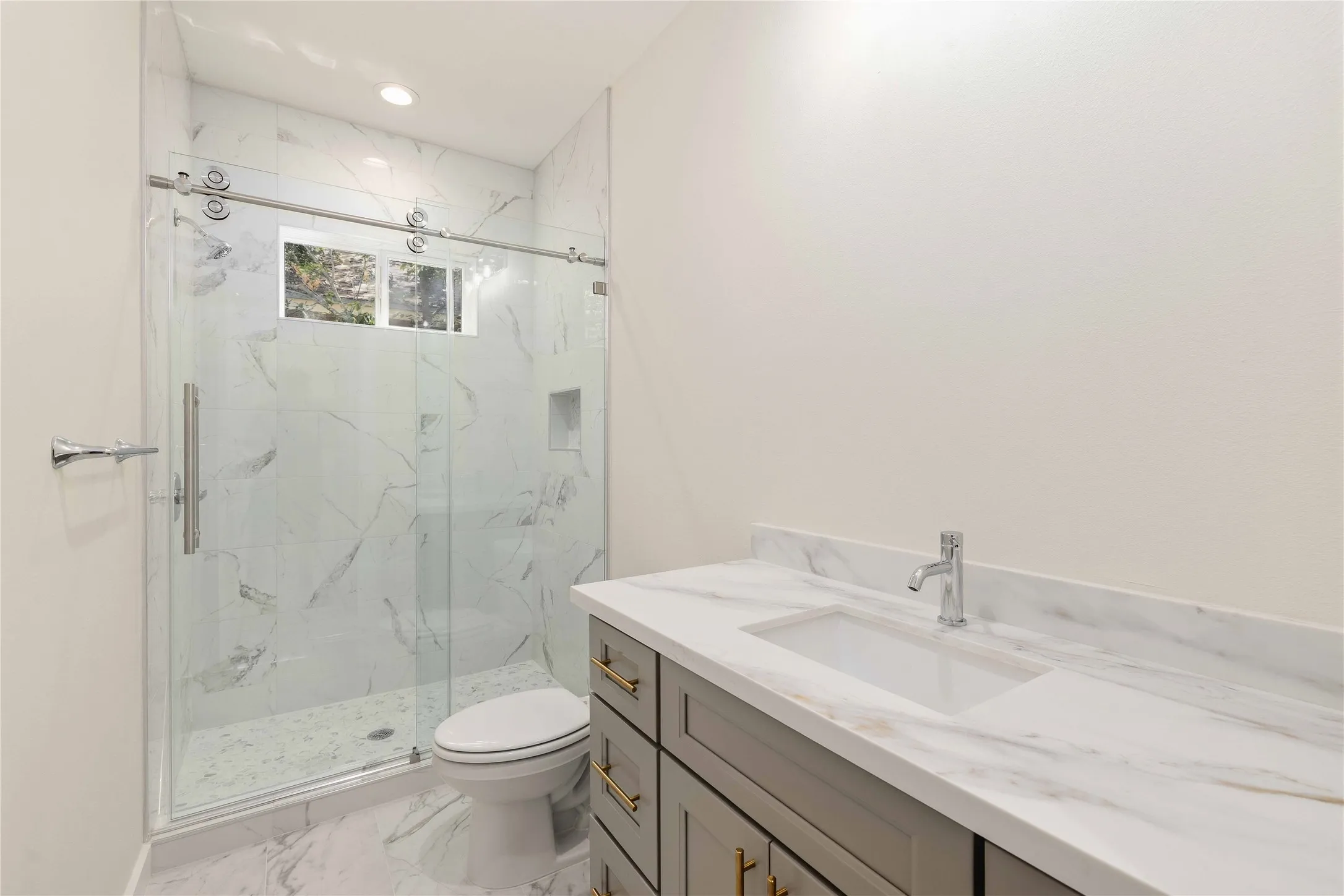 Walk-in shower with clear glass enclosure. Mirrors will be installed