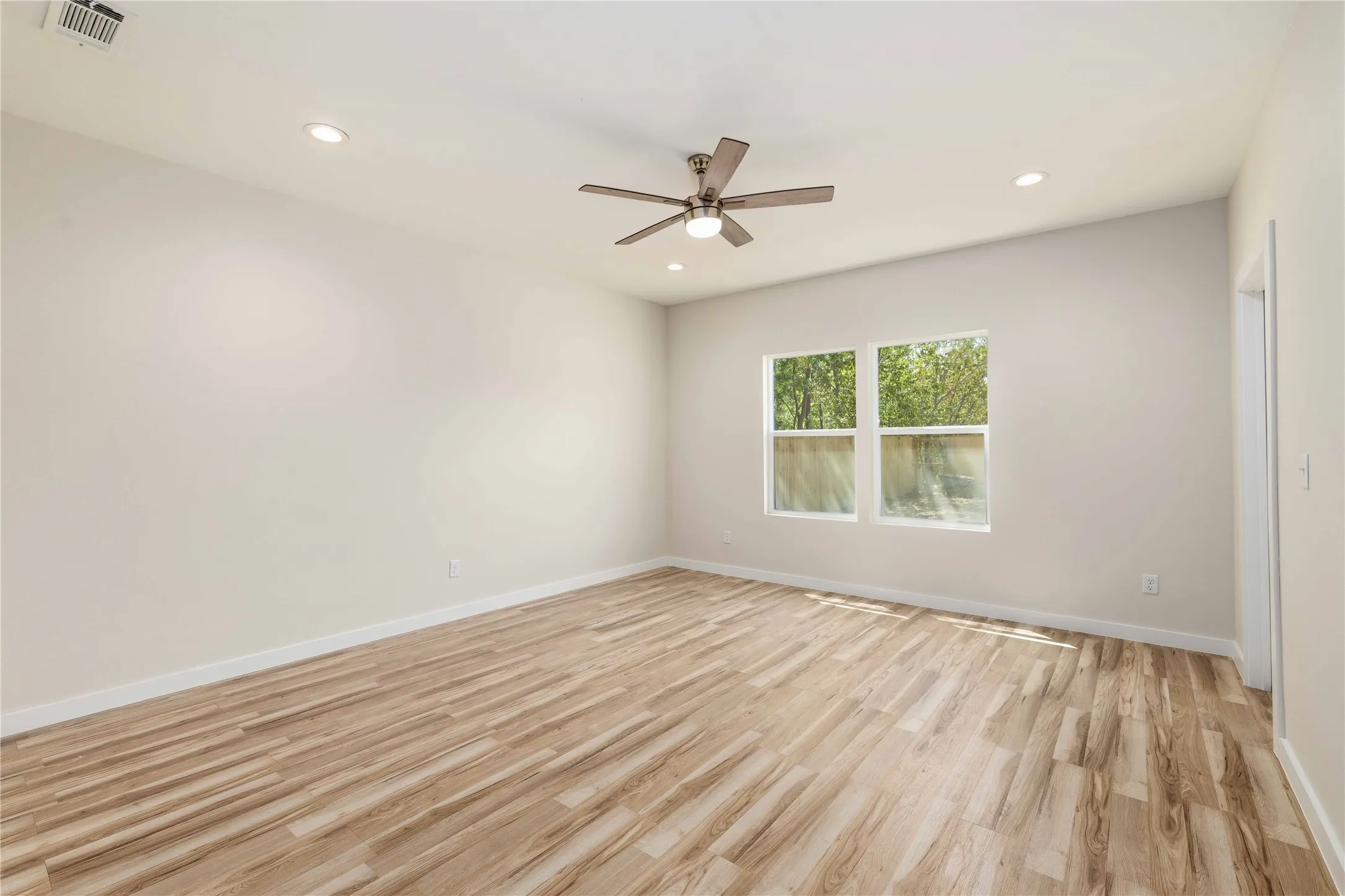 Wood-finish flooring throughout, paired with light-toned walls