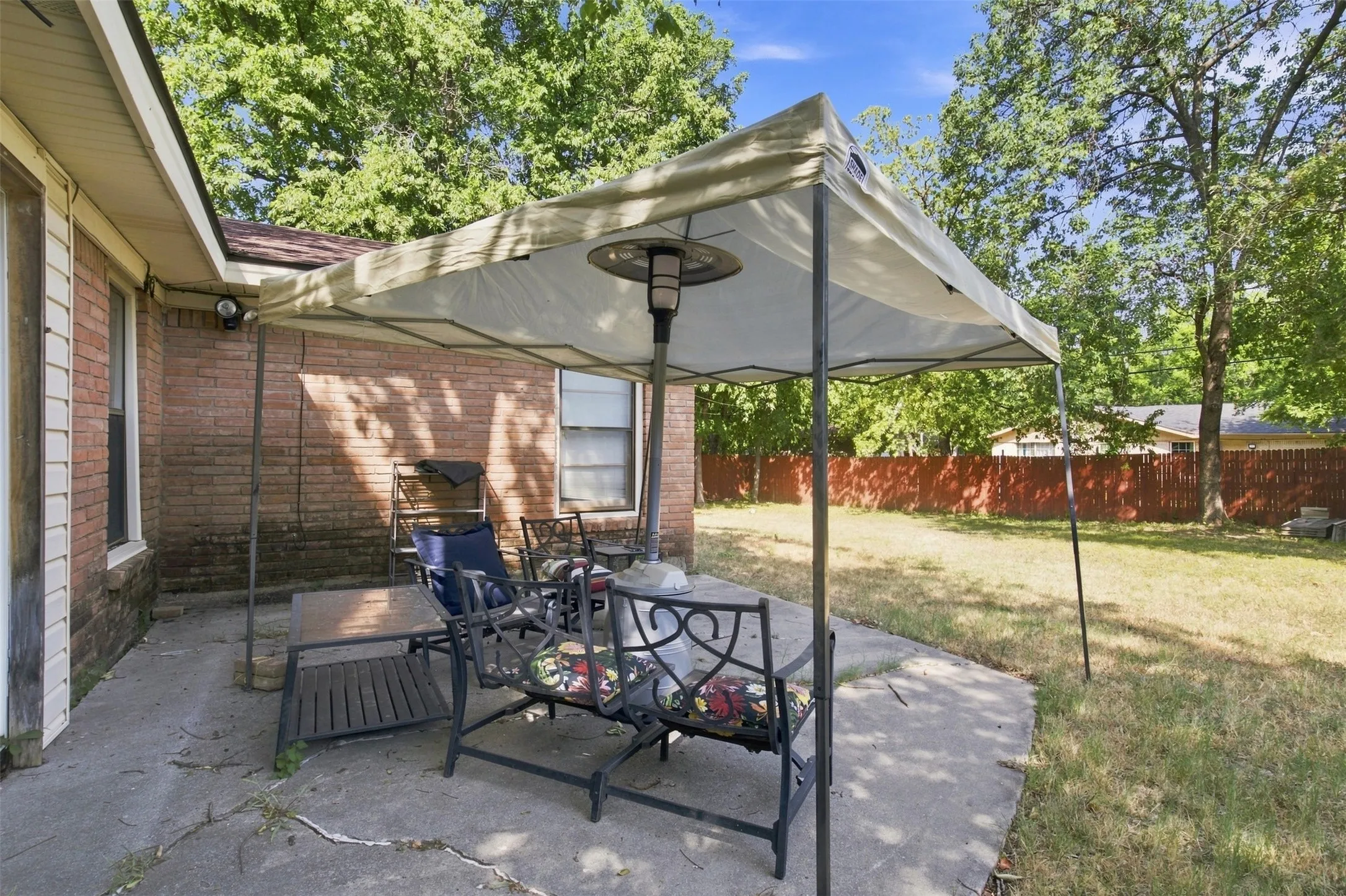 Expansive backyard featuring a concrete patio and a privacy fence