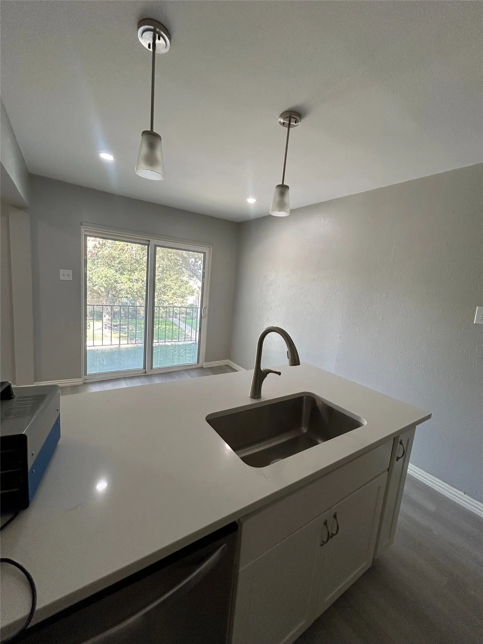 Kitchen island with an undermount stainless steel sink and a high-arch faucet