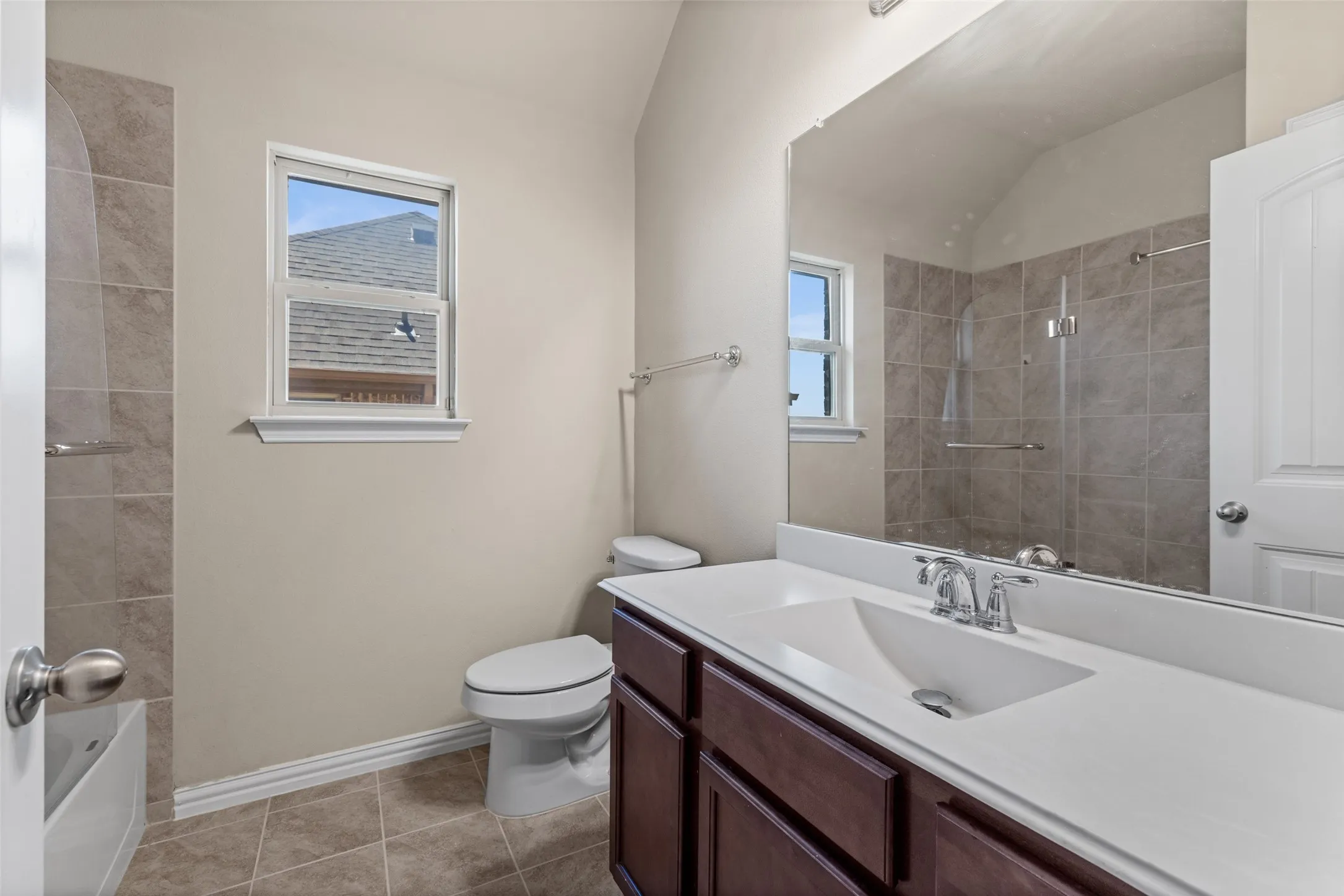 Wood-finish vanity with a white countertop and integrated sink