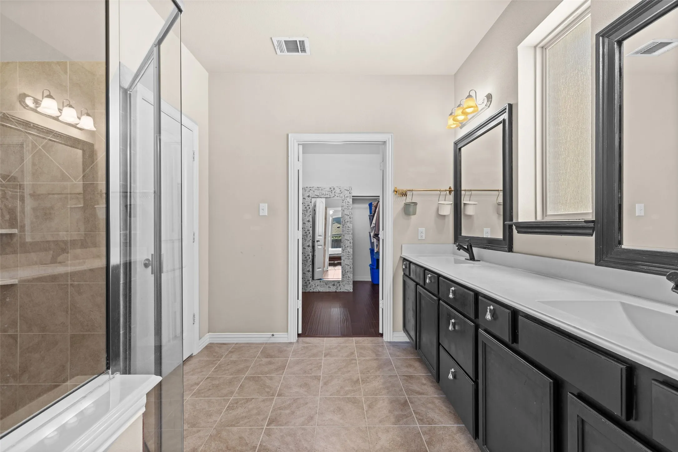 Dual vanity with undermount sinks and dark cabinetry