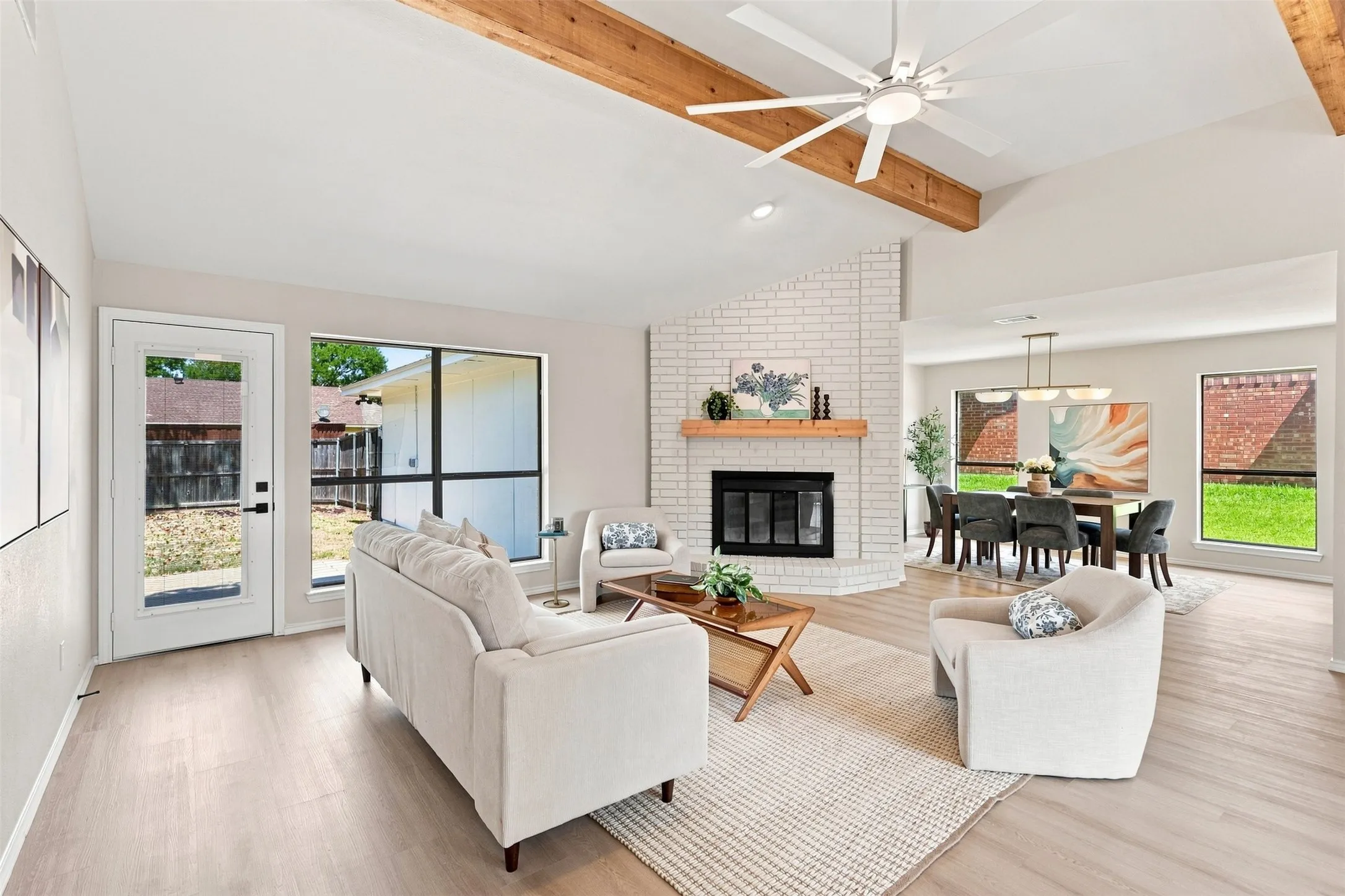Vaulted ceiling with exposed wood beams and a ceiling fan