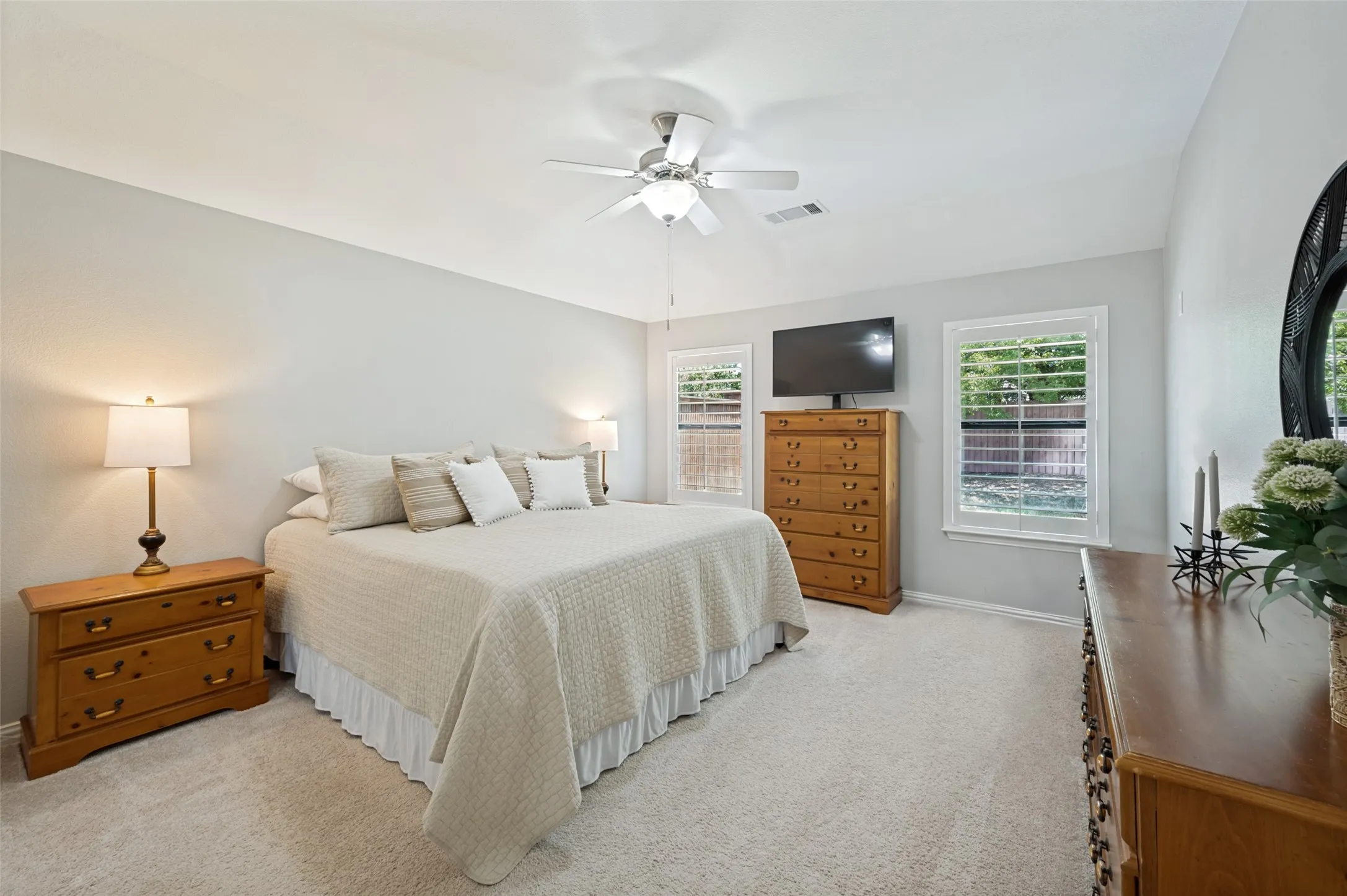 Well appointed room with Plantation shutters, and a ceiling fan