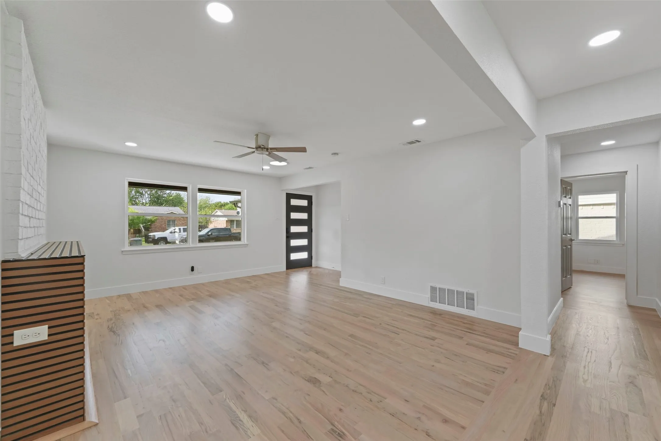 Living area featuring light hardwood flooring, recessed lighting, and a contemporary ceiling fan