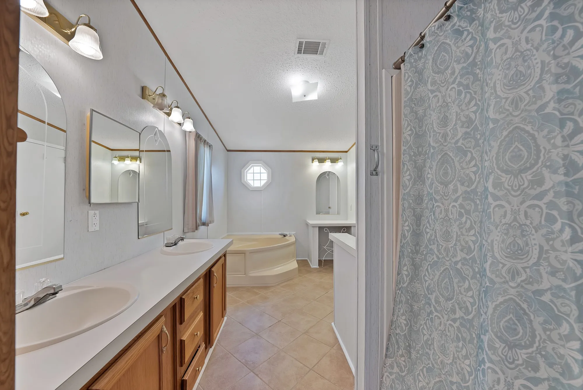Dual vanity with integral sinks and wood-finish cabinetry
